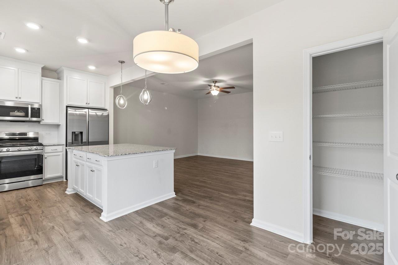 3776 Yorkshire Place Terrell, NC 28682 - Photo 7 of 47 a kitchen with white cabinets and stainless steel appliances