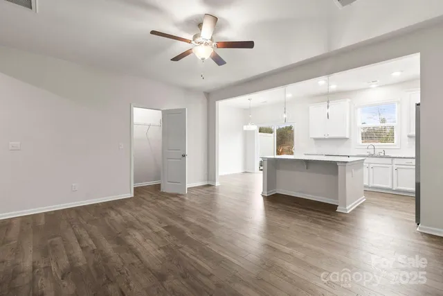 a view of kitchen with stove and cabinets