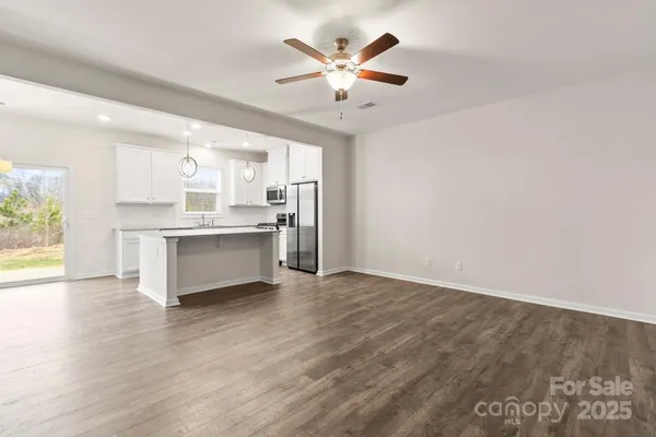 a kitchen with stainless steel appliances granite countertop a sink a refrigerator and a granite counter tops