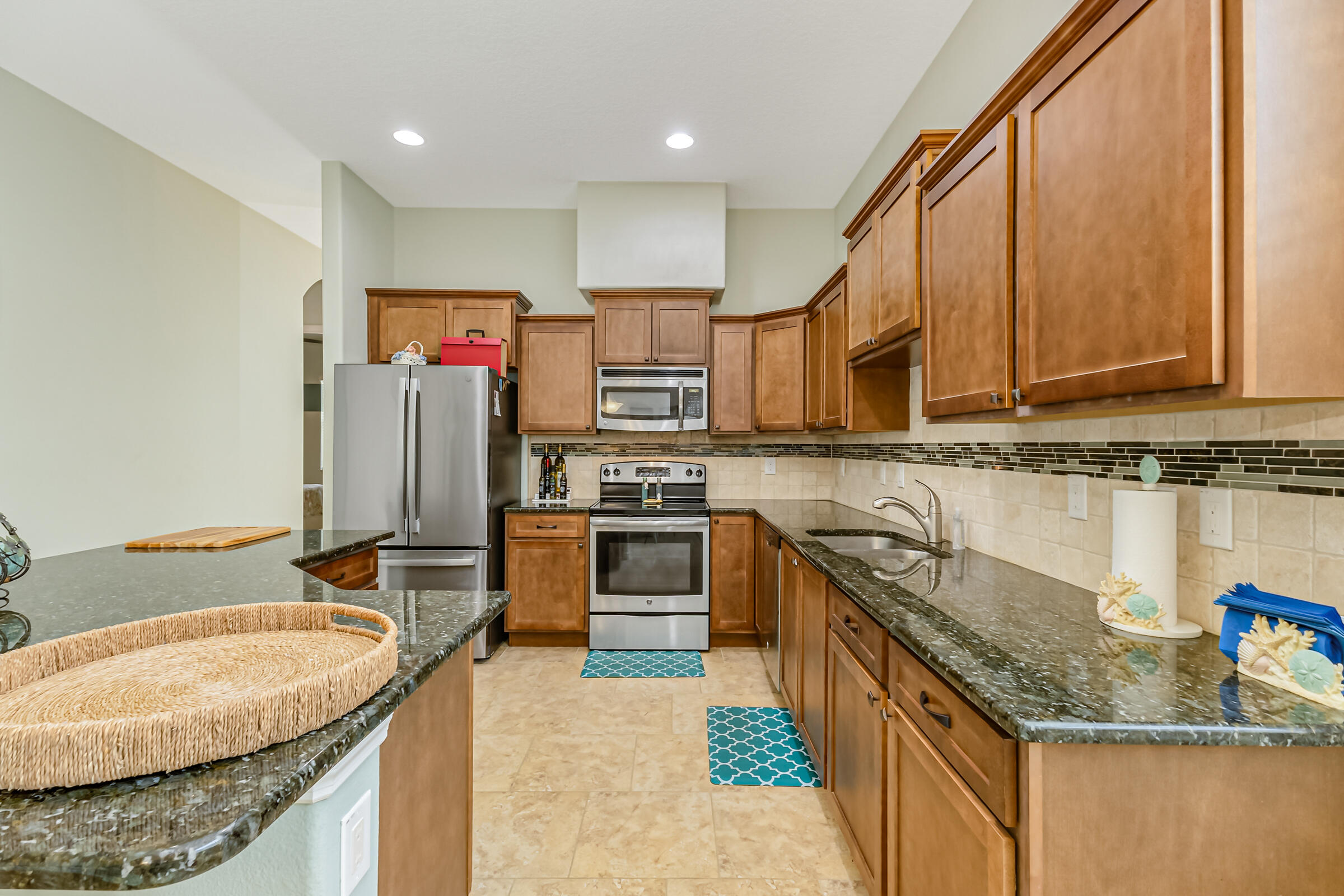 503 Heming Way Melbourne, FL 32901 - Photo 6 of 33 a kitchen with stainless steel appliances granite countertop a sink stove and refrigerator