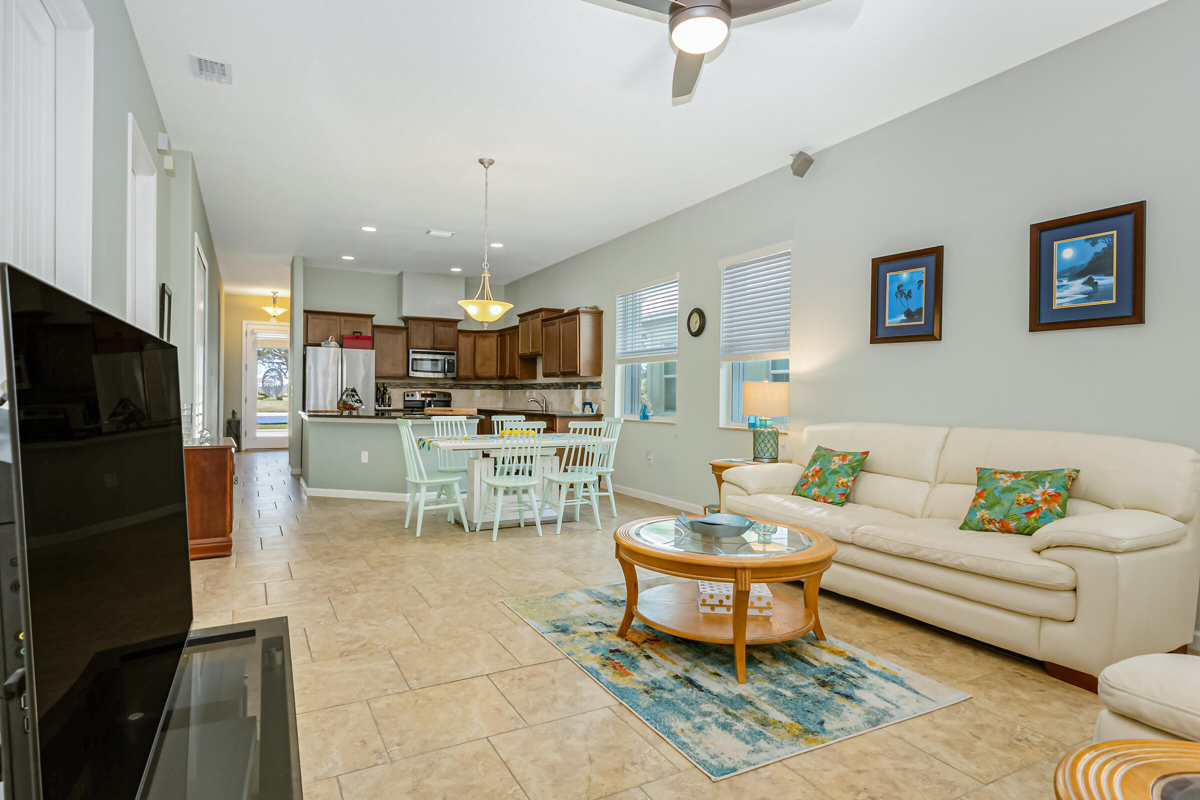 503 Heming Way Melbourne, FL 32901 - Photo 8 of 33 a living room with furniture a kitchen view and a fireplace