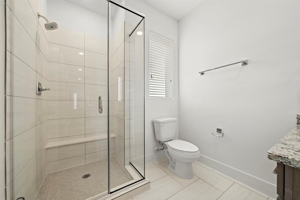 1586 West Tidwell Road Houston, TX 77091 - Photo 7 of 14 a bathroom with a shower and a toilet