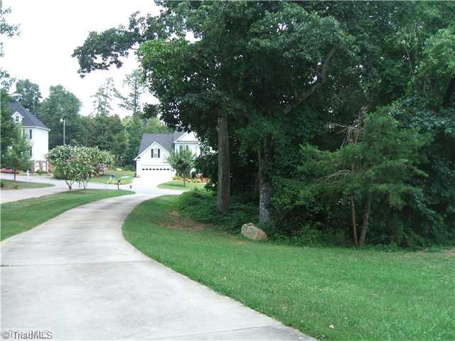 344 Clay Flynt Road Kernersville, NC 27284 - Photo 3 of 15 Exterior Front. Wooded side yard with creek & extra lot unlikely to developed.