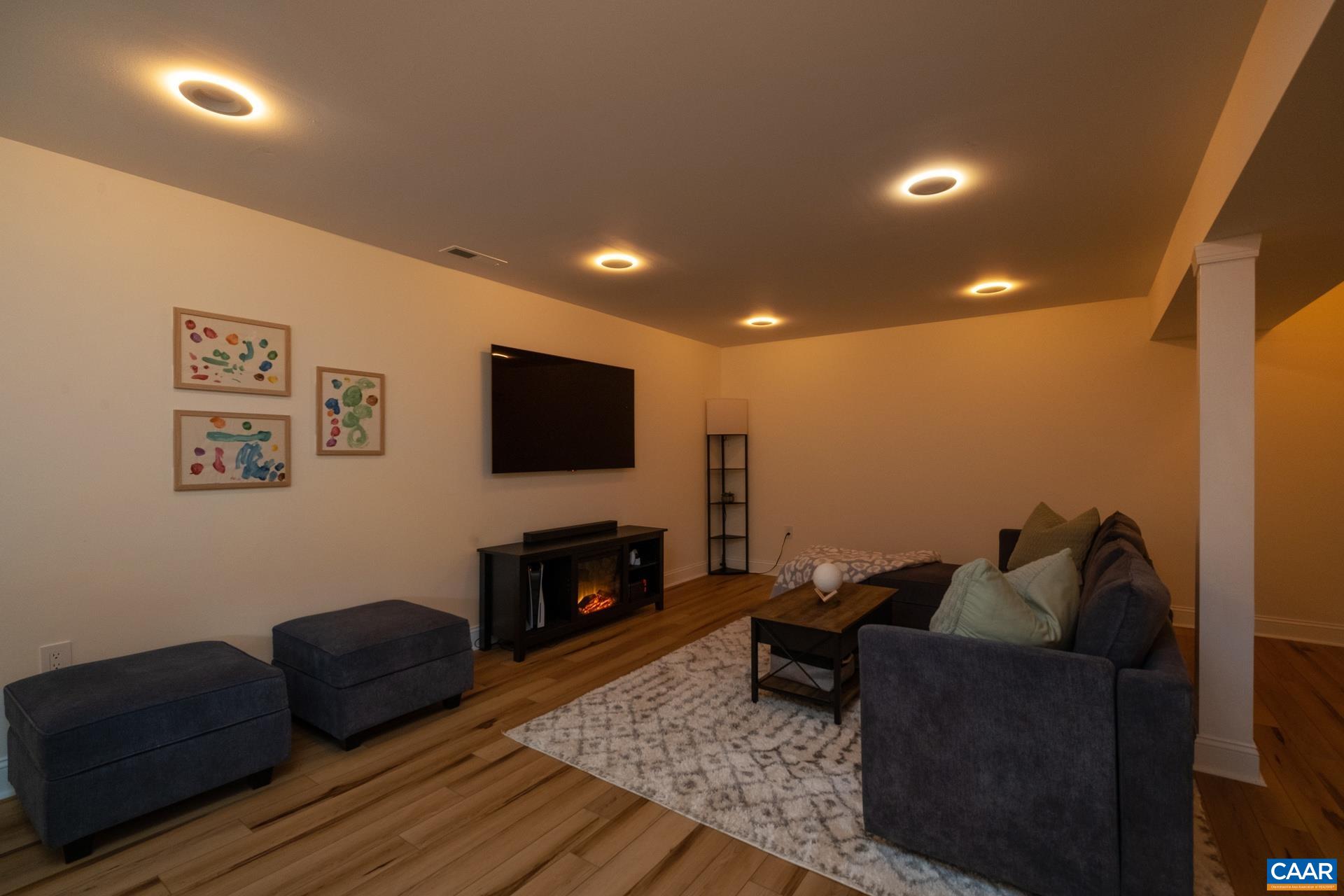 793 Geranium Road Ruckersville, VA 22968 - Photo 19 of 31 a living room with furniture and a flat screen tv