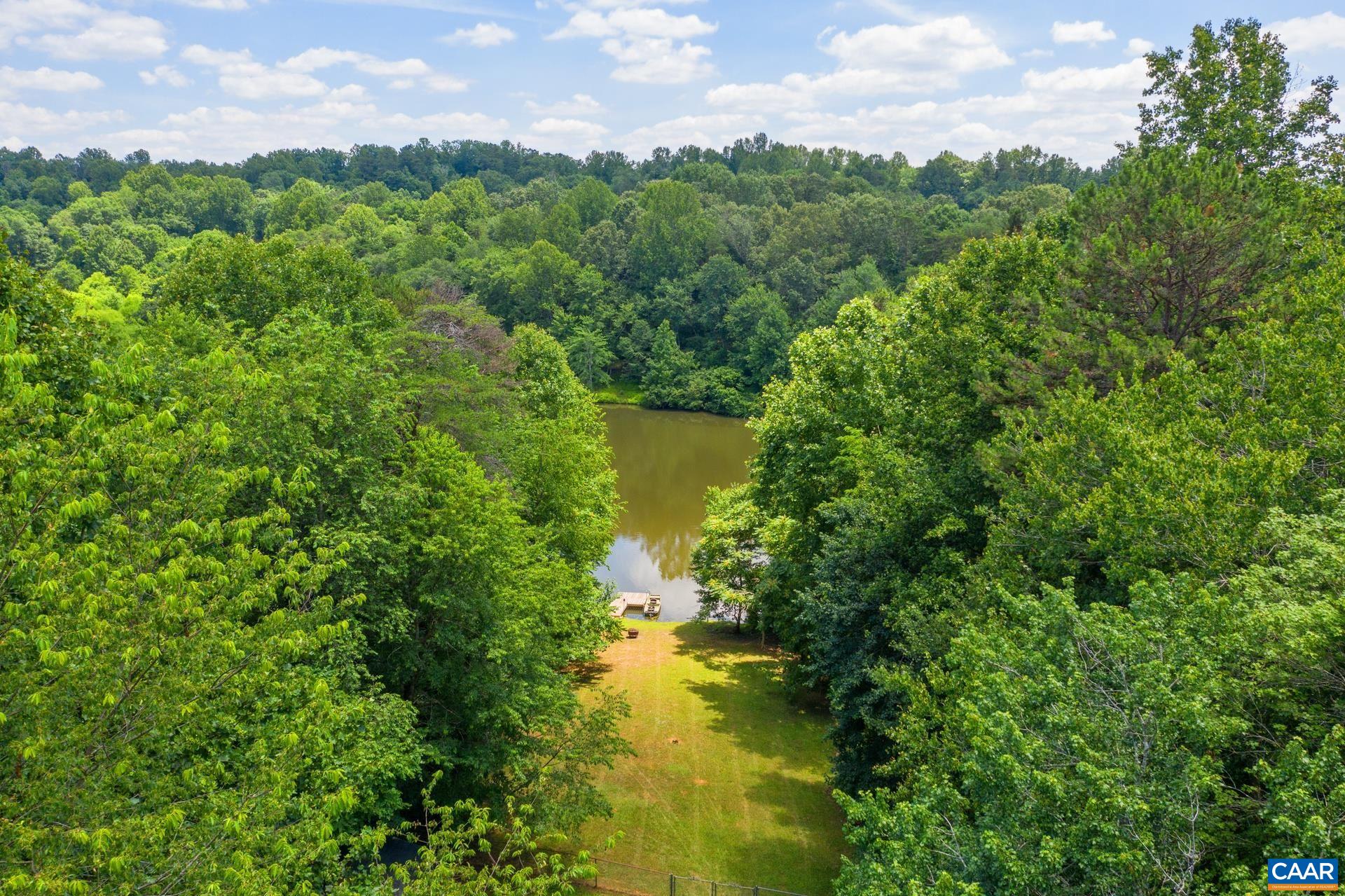 793 Geranium Road Ruckersville, VA 22968 - Photo 25 of 31 a view of a lake with houses in back