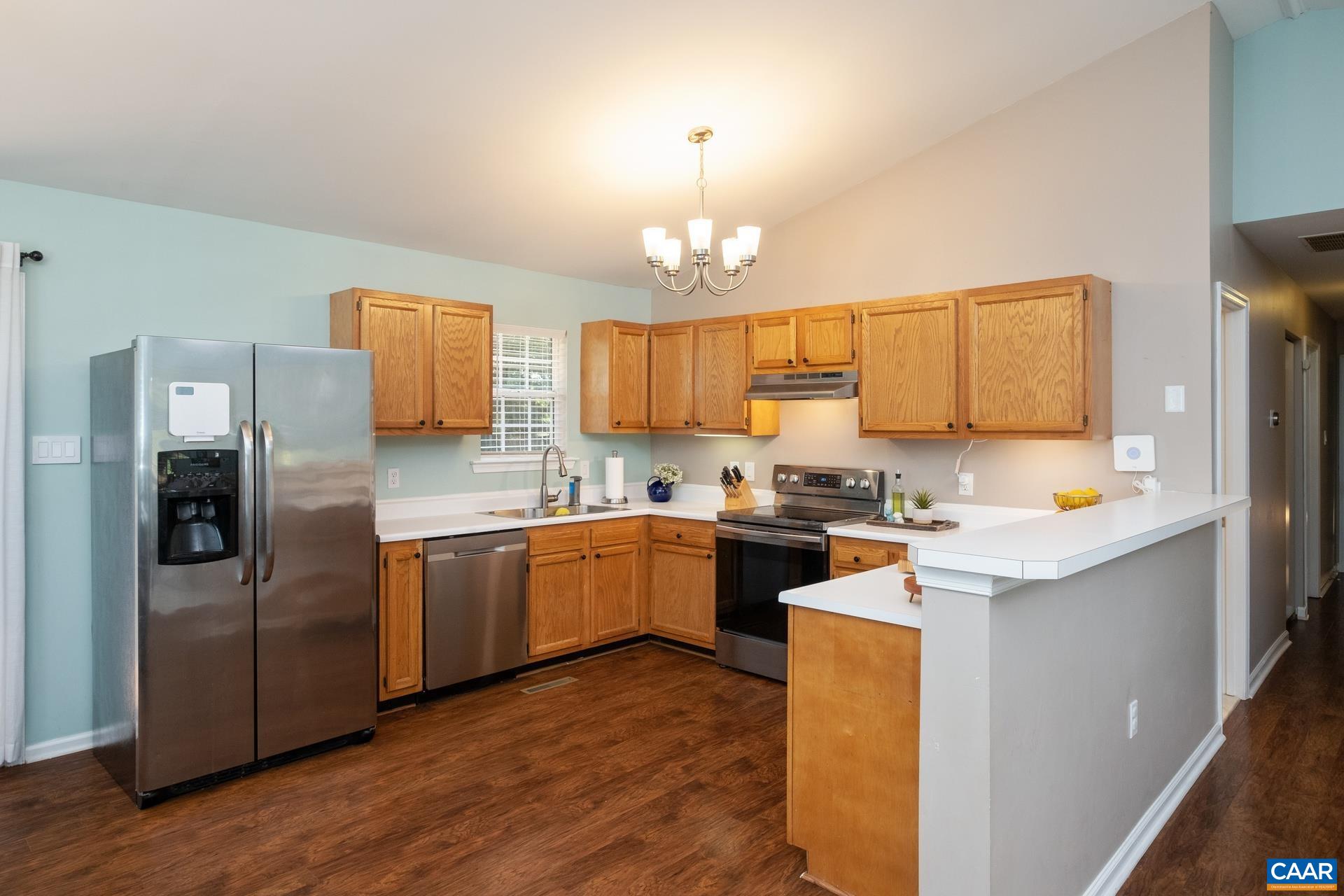 793 Geranium Road Ruckersville, VA 22968 - Photo 8 of 31 a kitchen with stainless steel appliances granite countertop a refrigerator a sink dishwasher a stove with wooden cabinets and floor