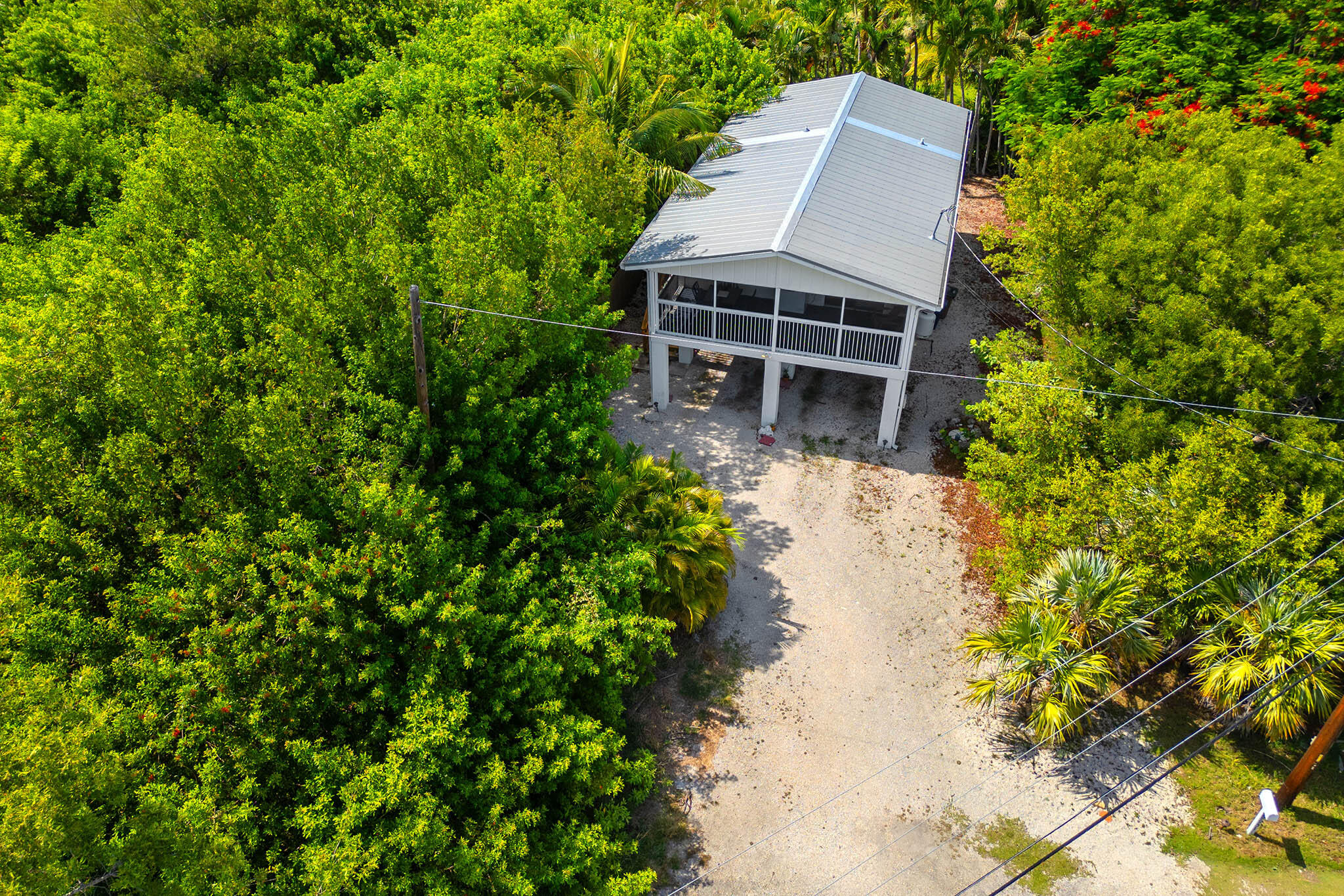 29951 Pine Channel Road Big Pine Key, FL 33043 - Photo 13 of 61 an aerial view of a house with a yard and large trees