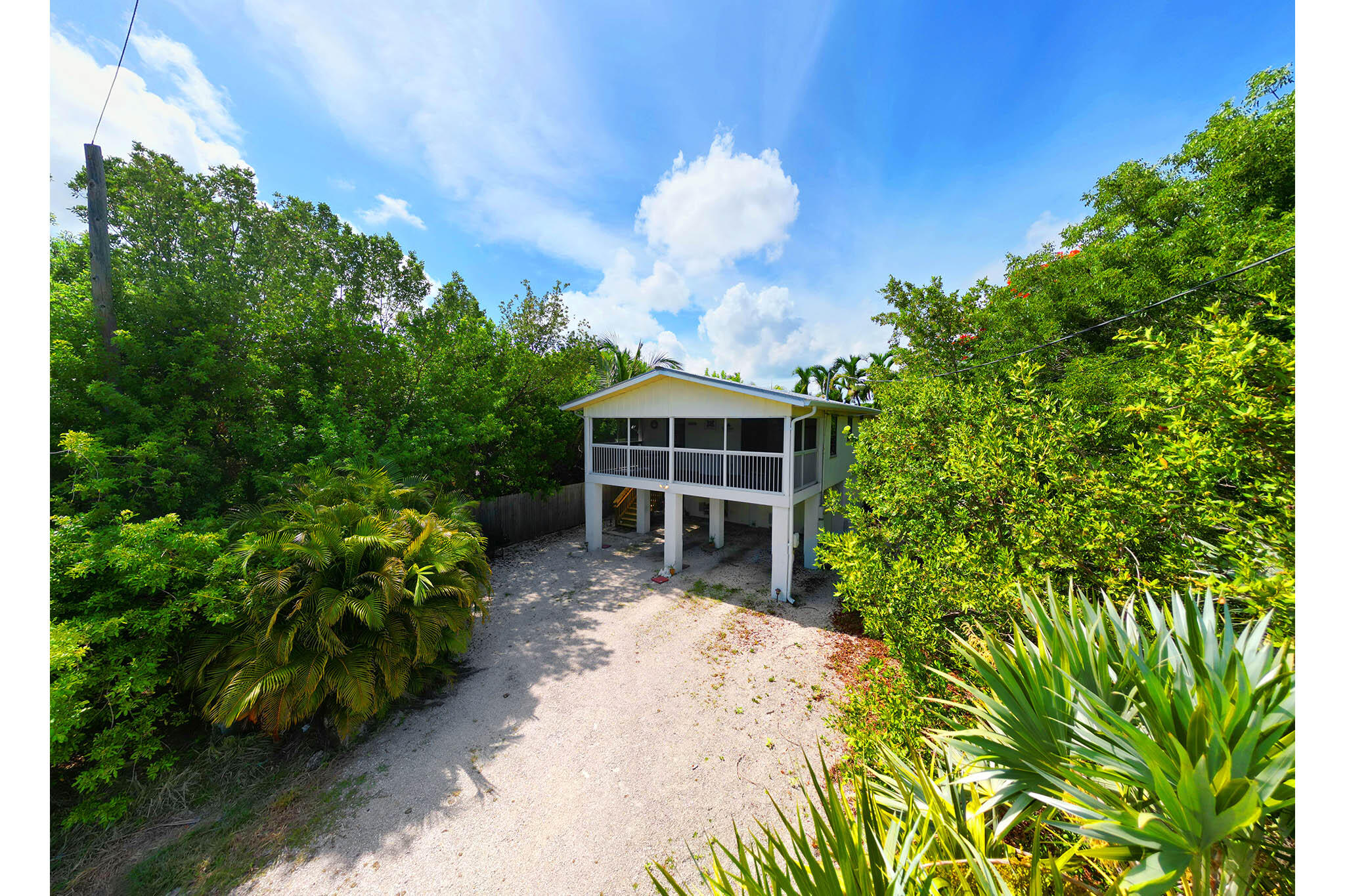29951 Pine Channel Road Big Pine Key, FL 33043 - Photo 15 of 61 a front view of a house with a yard and fountain in middle