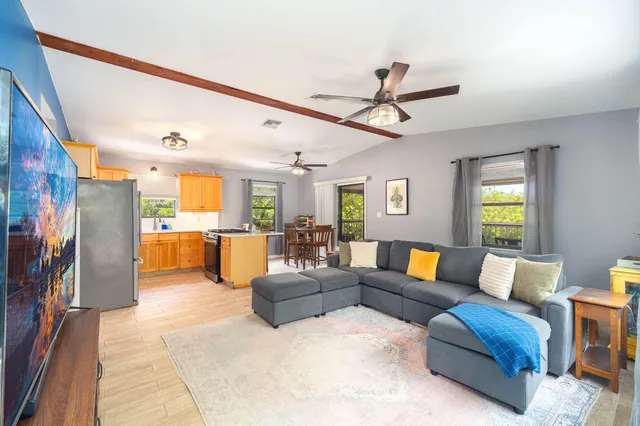 a living room with furniture and a flat screen tv