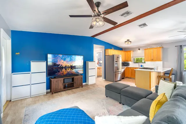 a dining room with a wooden table and chairs