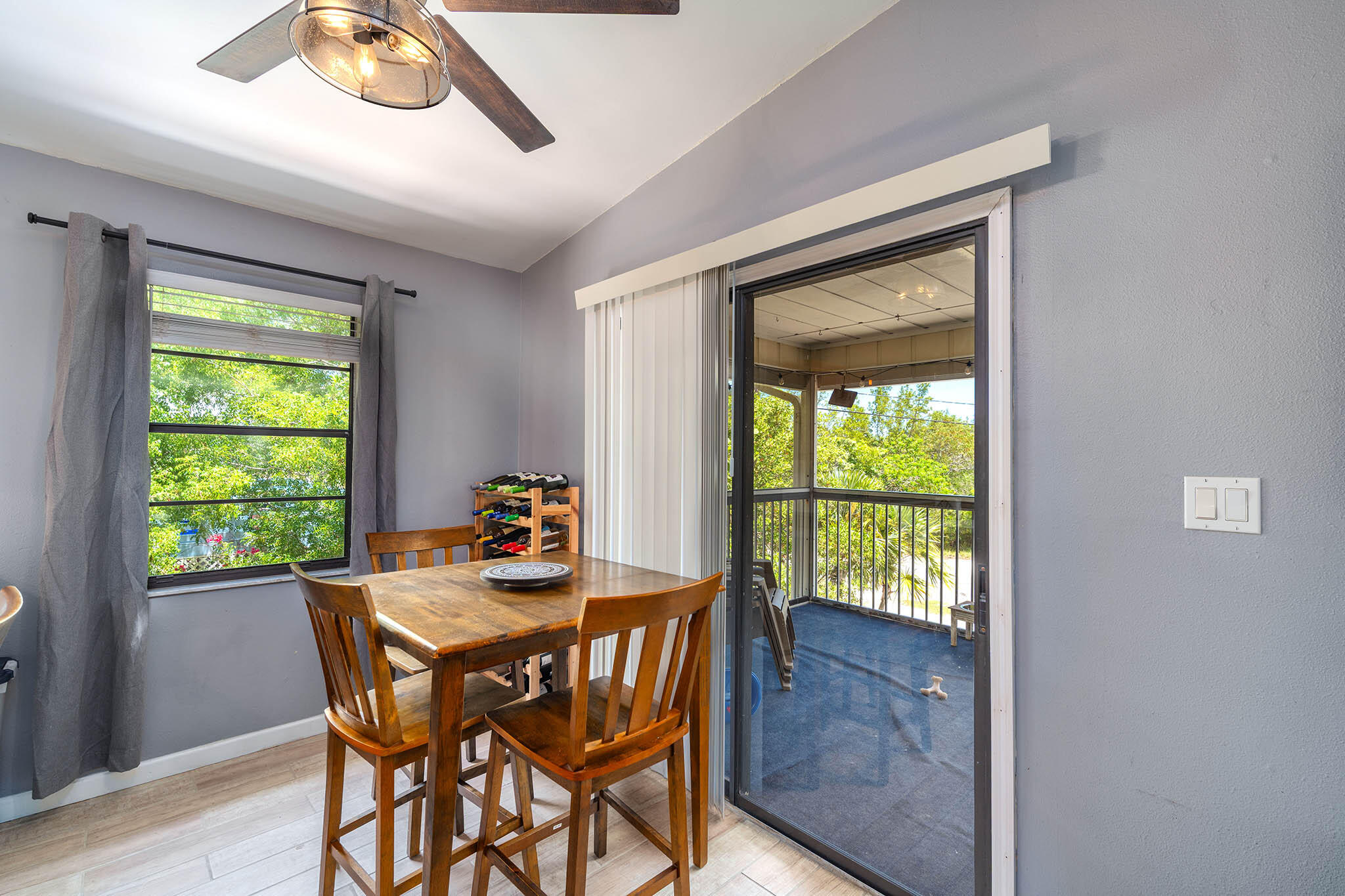 29951 Pine Channel Road Big Pine Key, FL 33043 - Photo 21 of 61 a dining room with a wooden table and chairs