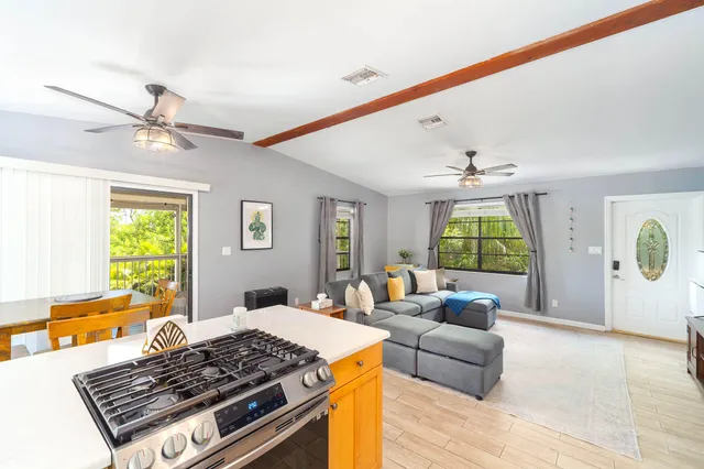 a view of a hallway with wooden floor and windows