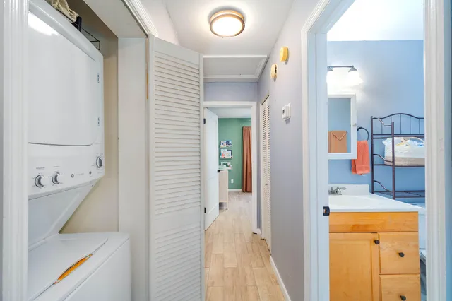 a bedroom with furniture and a large window