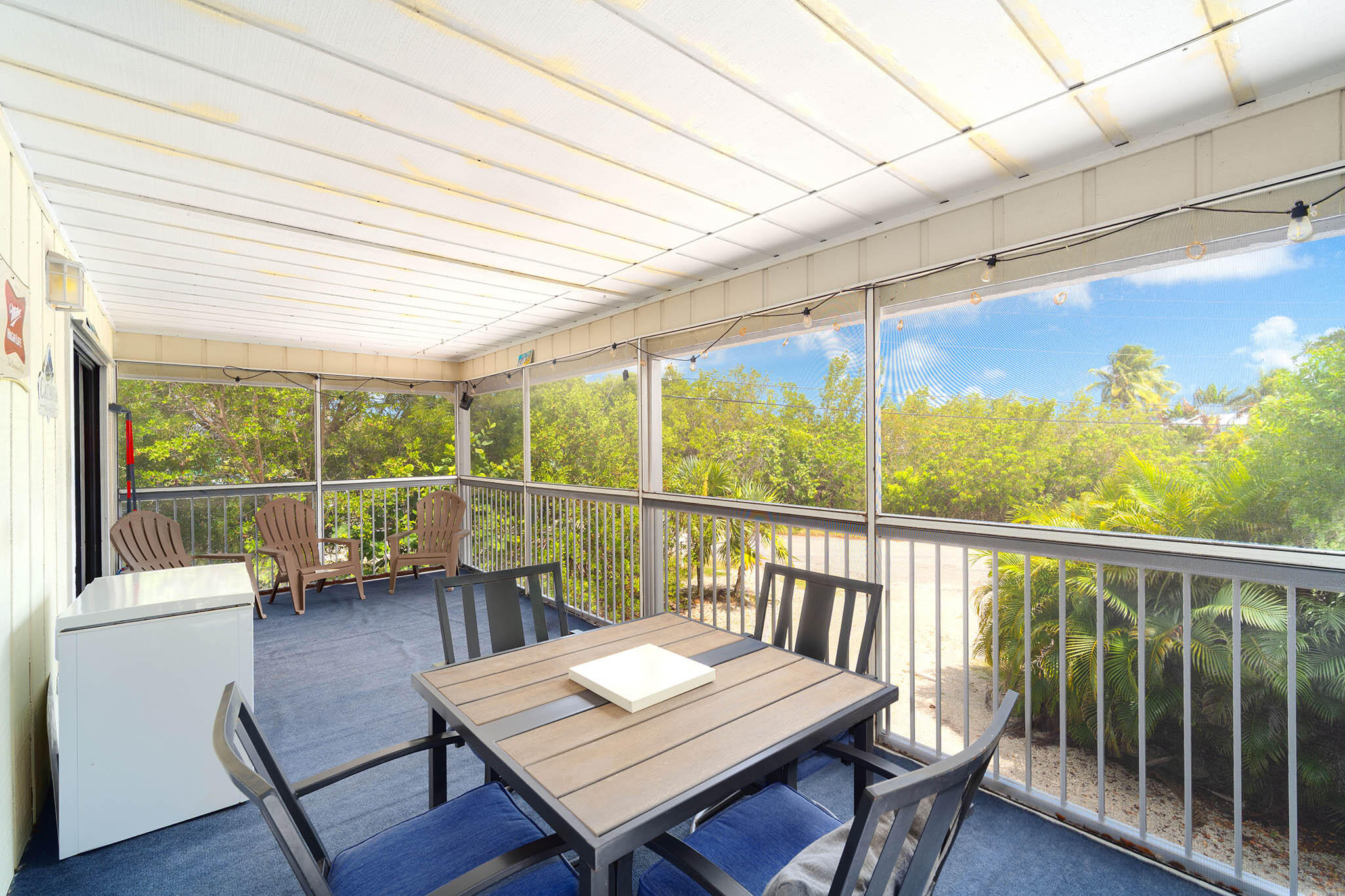 29951 Pine Channel Road Big Pine Key, FL 33043 - Photo 43 of 61 a view of a balcony with wooden floor and outdoor seating