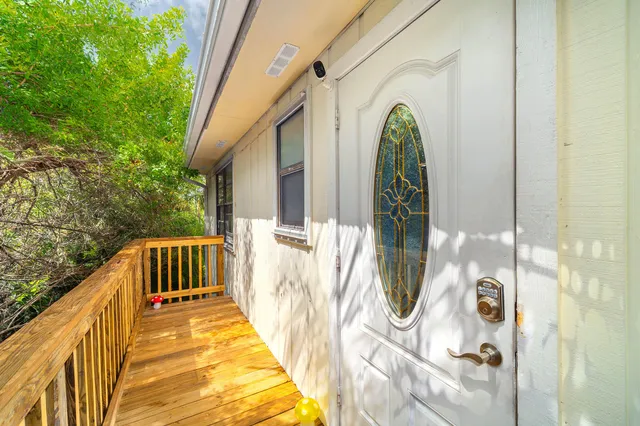 a view of a white house with a yard