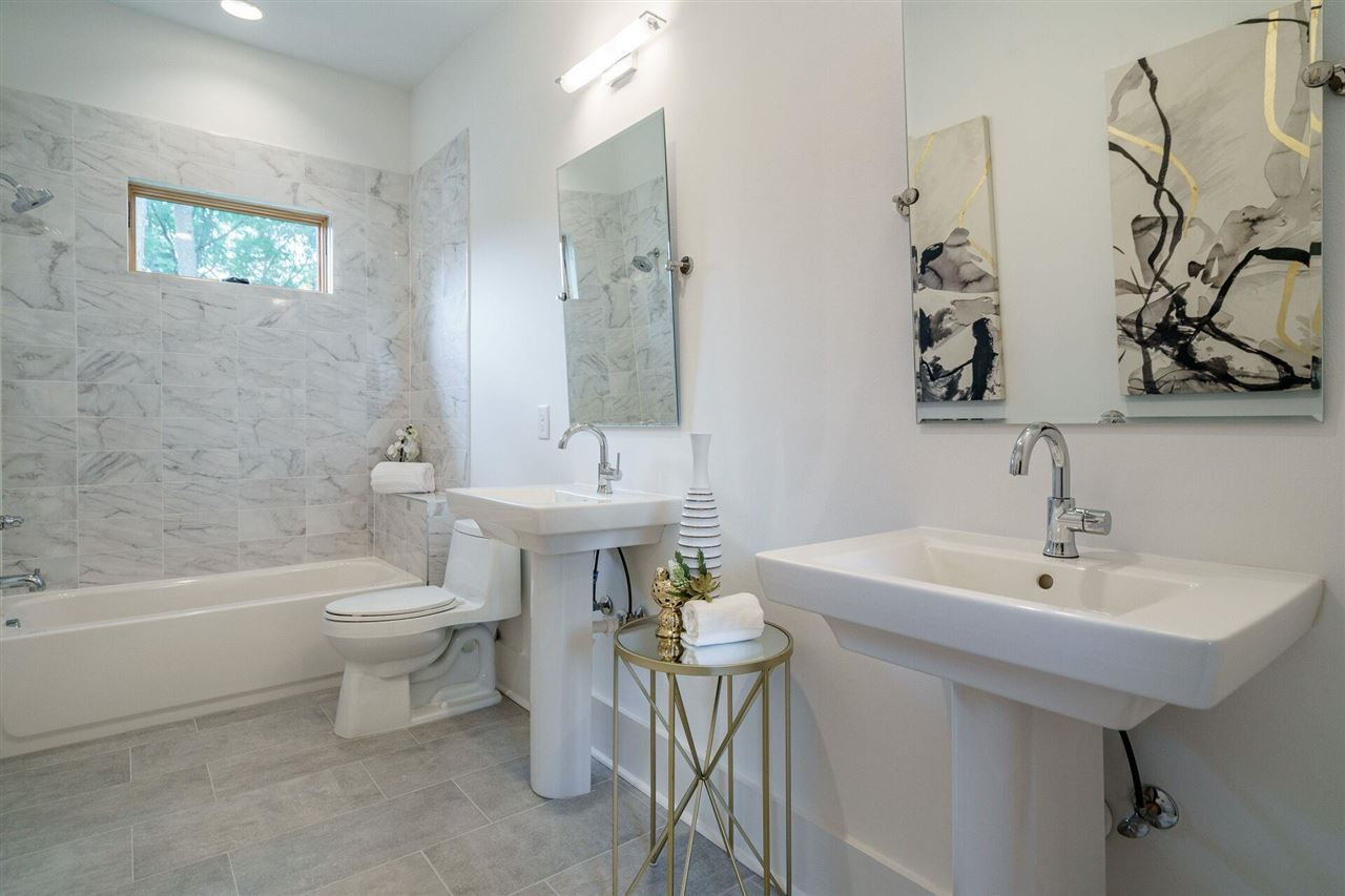 1619 Lorraine Road Raleigh, NC 27607 - Photo 23 of 30 This large Second Floor Full Bathroom serves two Bedroom and the Bonus Room. Two Pedestal Sinks, Sleek and calming finishes. Second Floor Full Bathroom