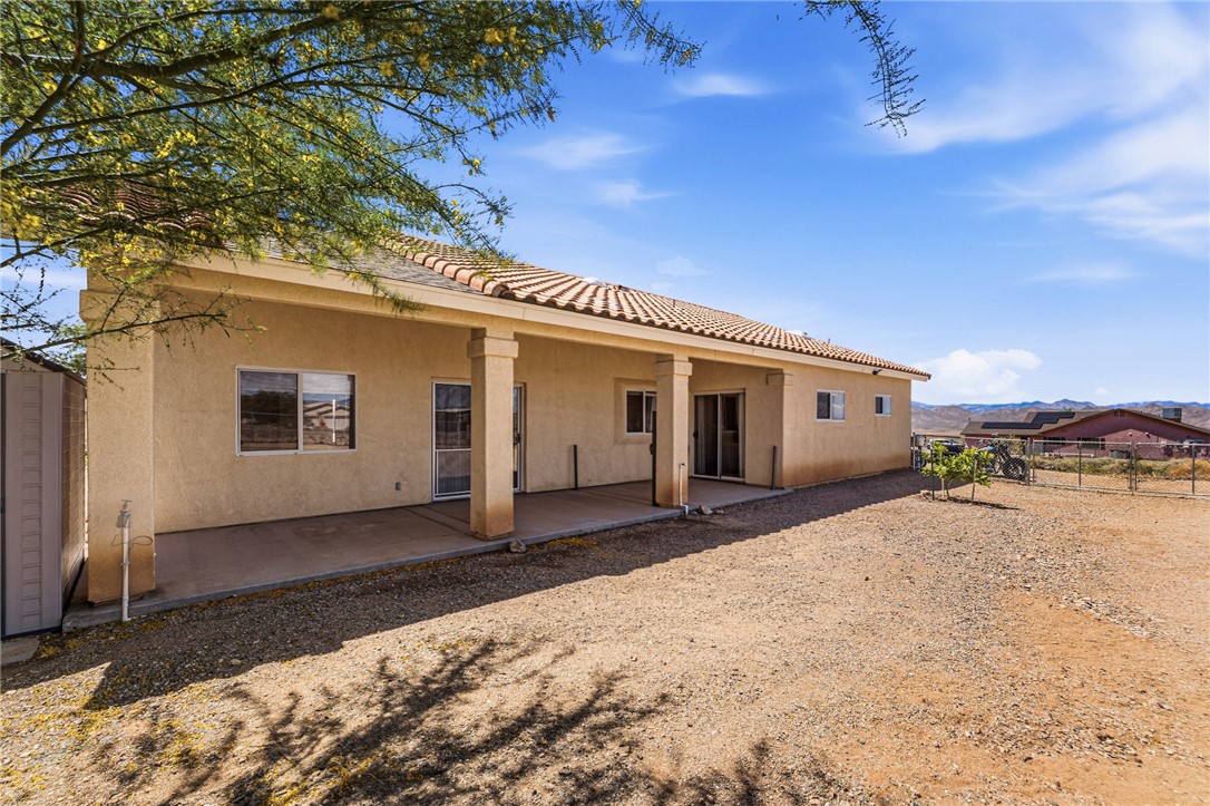 9332 Branded Road Kingman, AZ 86401 - Photo 34 of 44 a front view of a house with a yard