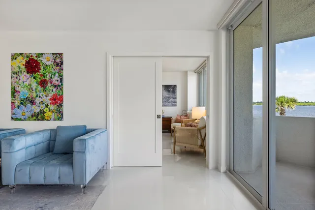 a living room with furniture and a lamp