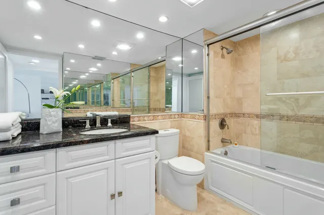 a view of a kitchen with kitchen island a counter top space a sink and appliances