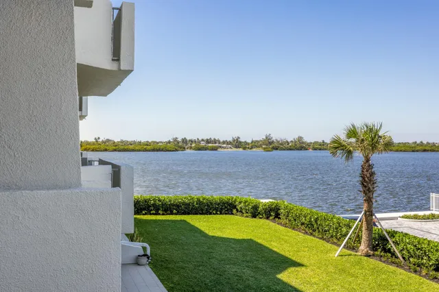 a living room with furniture and a painting on the wall