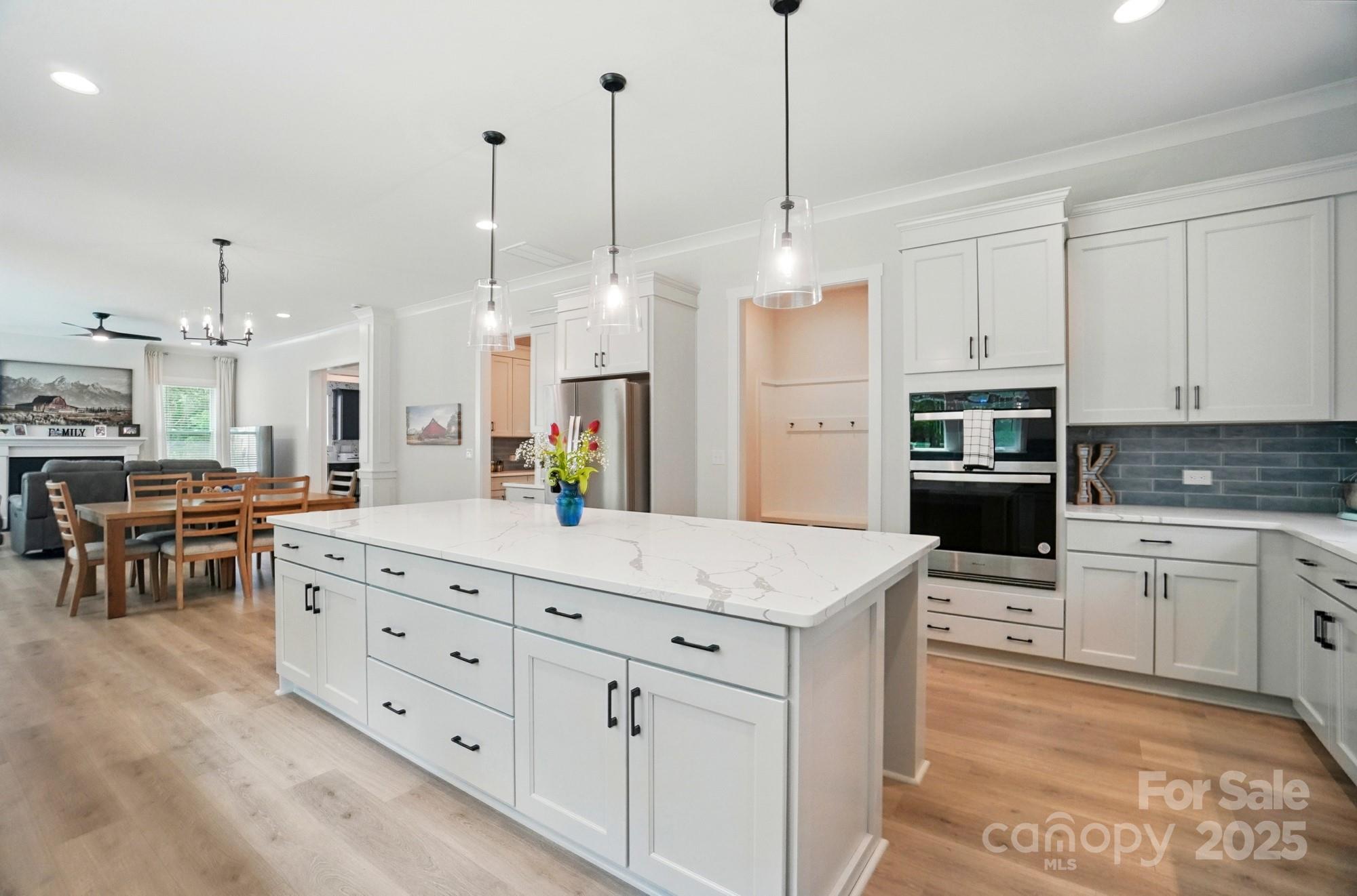 7818 Russell Road Indian Trail, NC 28079 - Photo 11 of 42 a large kitchen with kitchen island a large counter space appliances and cabinets