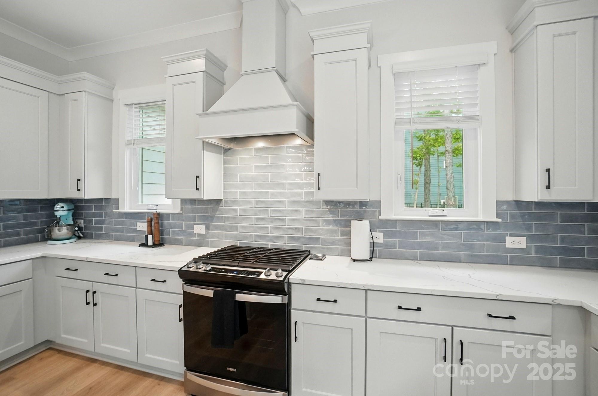 7818 Russell Road Indian Trail, NC 28079 - Photo 13 of 42 a kitchen with stainless steel appliances a sink stove and cabinets