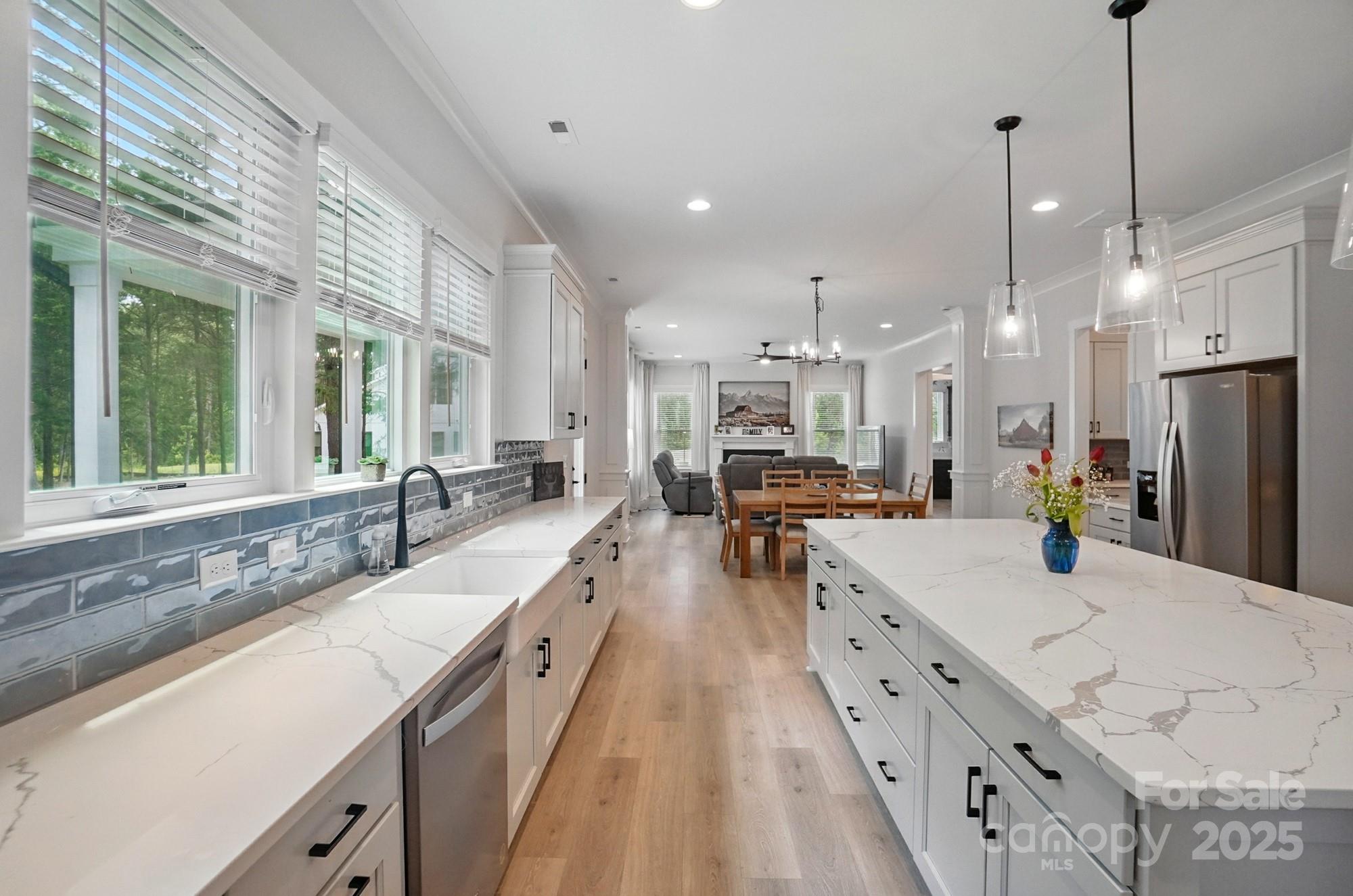7818 Russell Road Indian Trail, NC 28079 - Photo 15 of 42 a large white kitchen with a large window and stainless steel appliances