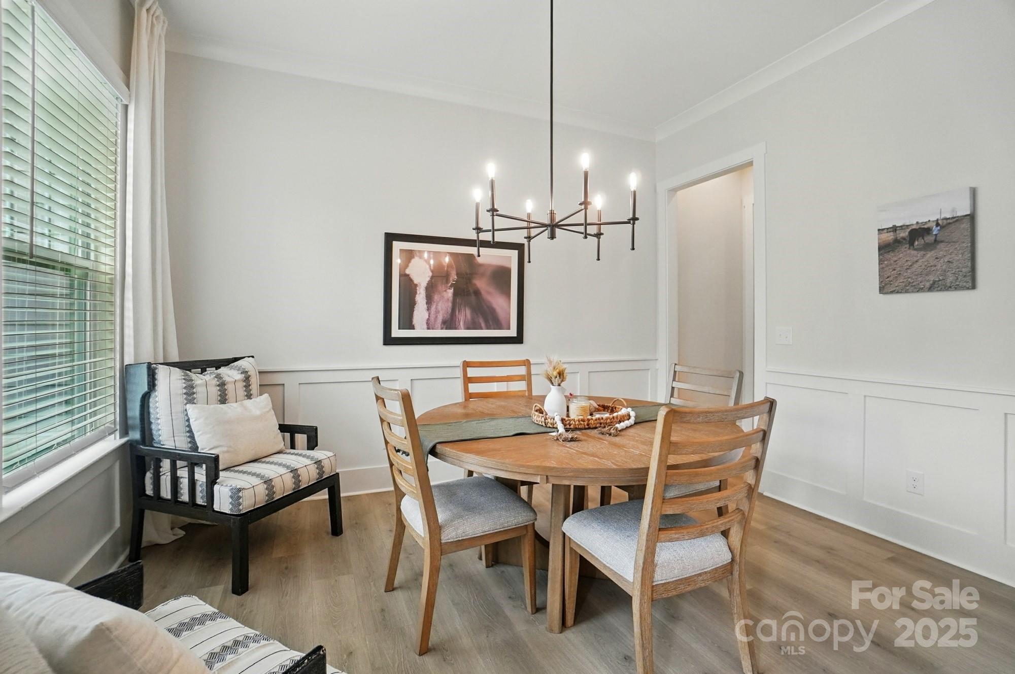 7818 Russell Road Indian Trail, NC 28079 - Photo 16 of 42 a view of a dining room with furniture window and wooden floor
