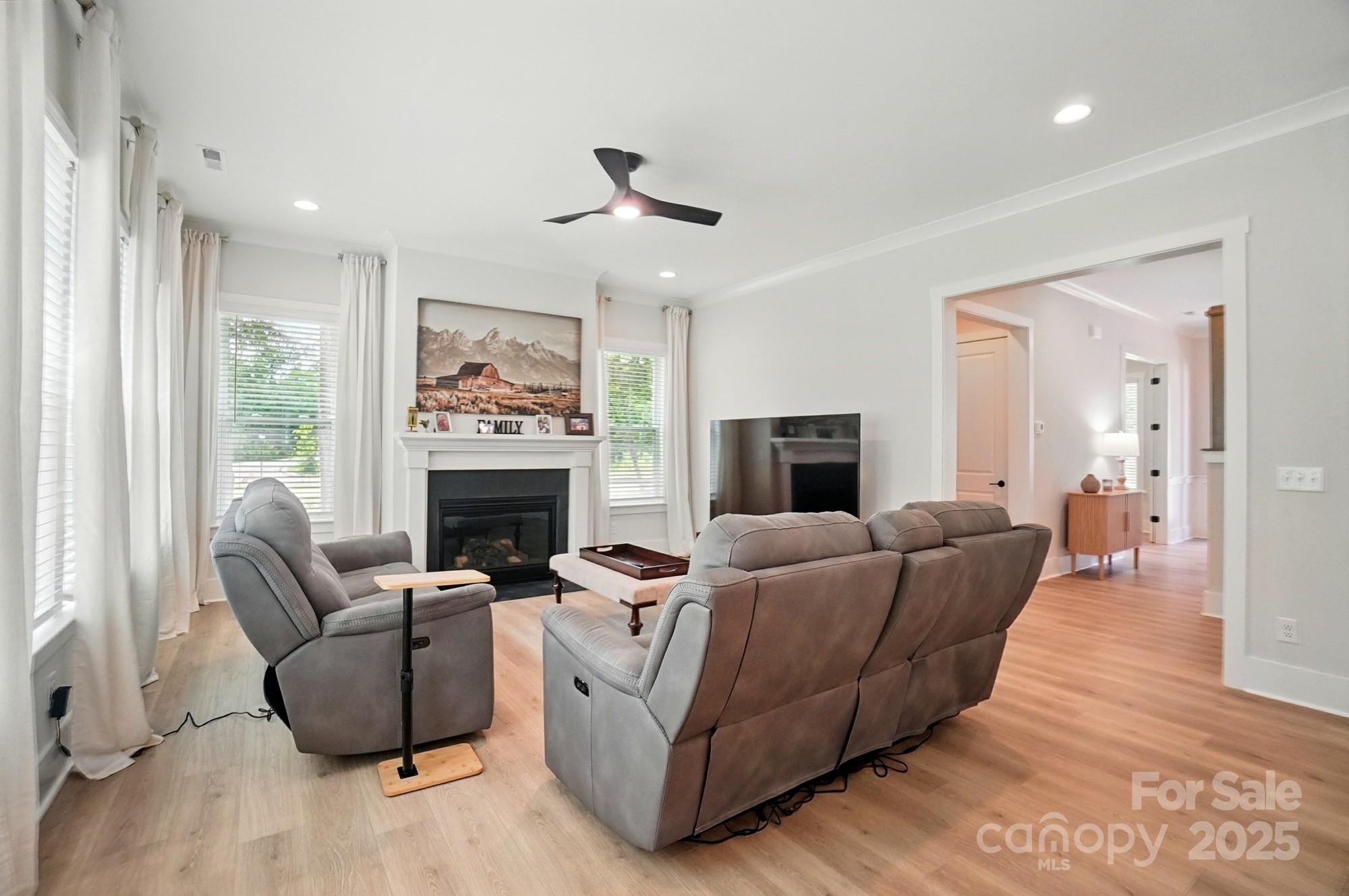 7818 Russell Road Indian Trail, NC 28079 - Photo 17 of 42 a living room with furniture a flat screen tv and a fireplace
