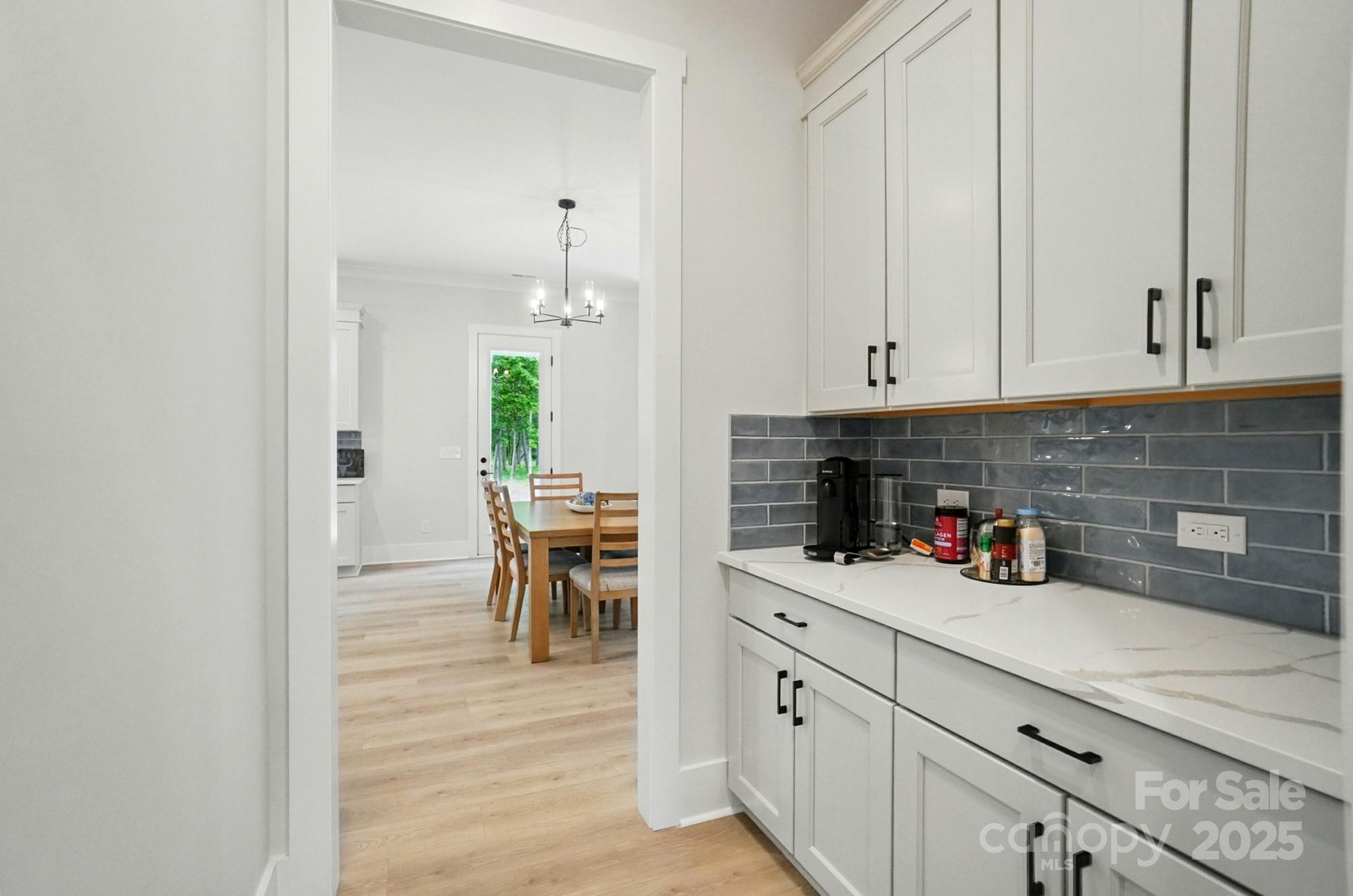 7818 Russell Road Indian Trail, NC 28079 - Photo 19 of 42 a kitchen with stainless steel appliances granite countertop a sink a stove and white cabinets