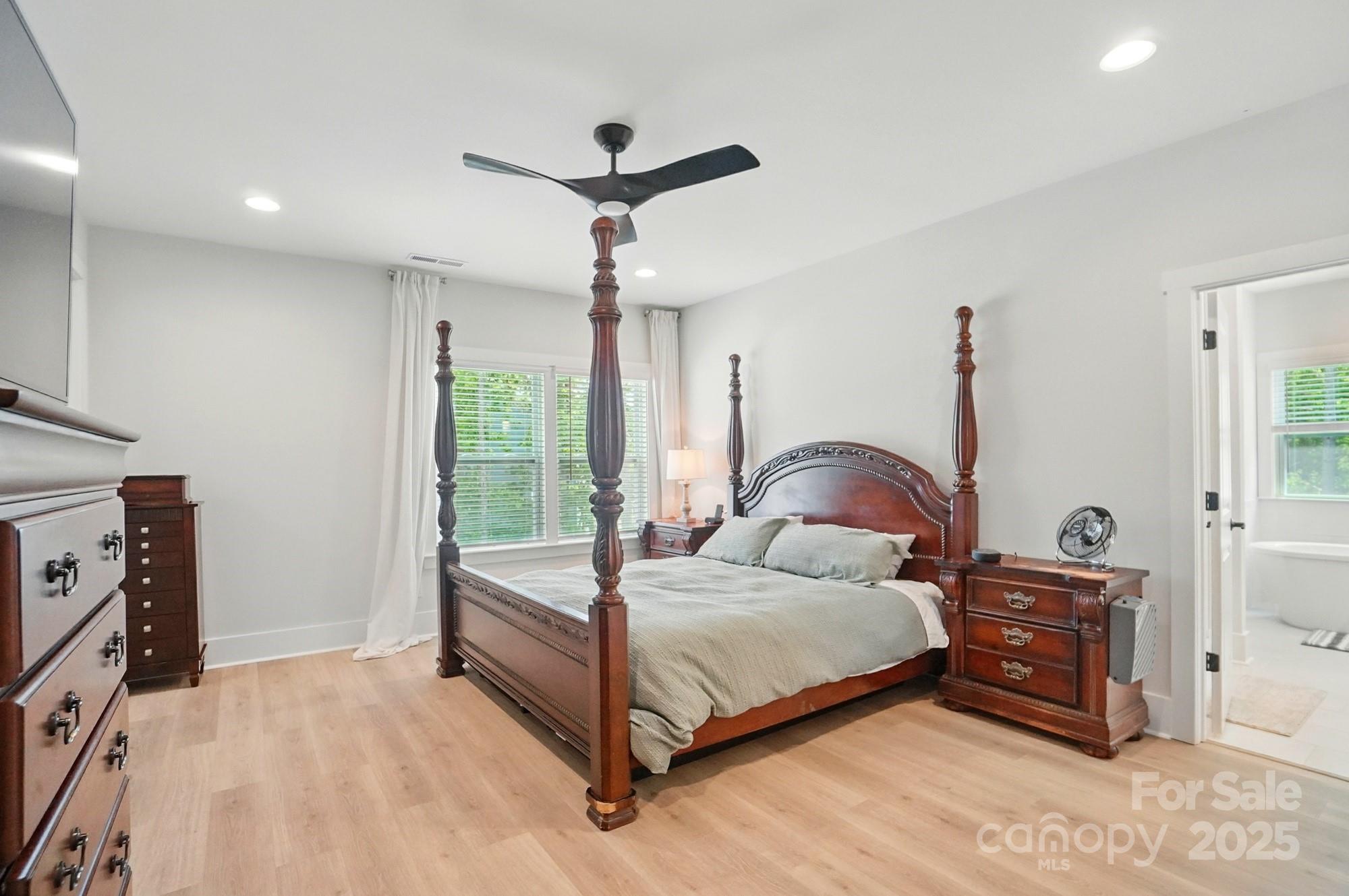 7818 Russell Road Indian Trail, NC 28079 - Photo 23 of 42 a bedroom with a bed and a tv