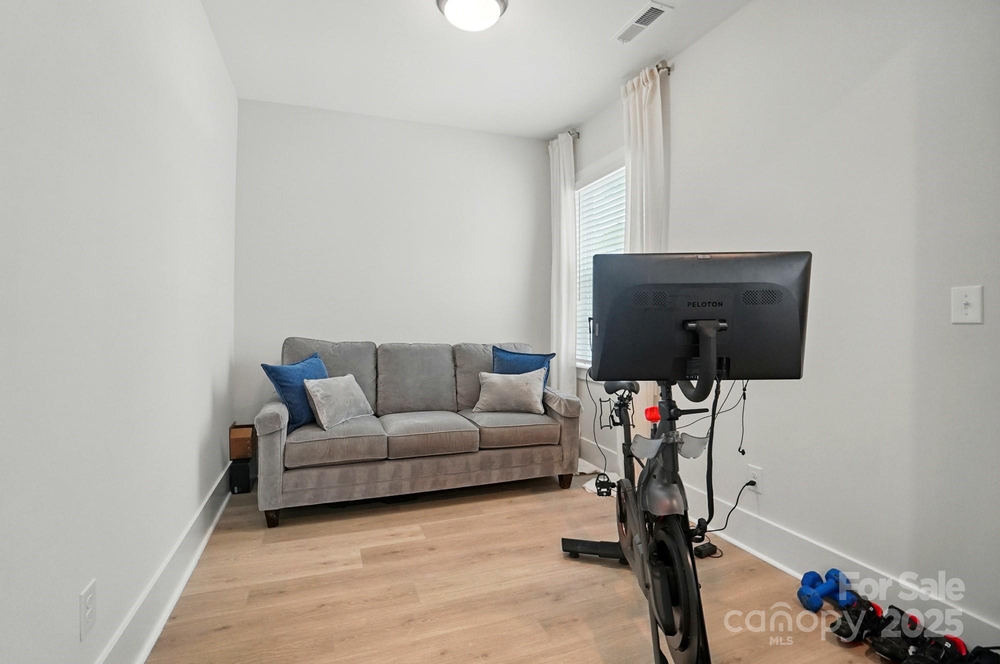 7818 Russell Road Indian Trail, NC 28079 - Photo 24 of 42 a living room with furniture and a flat screen tv