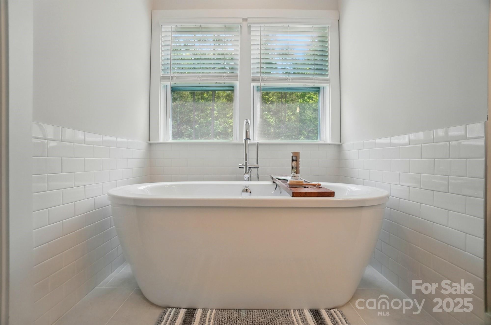 7818 Russell Road Indian Trail, NC 28079 - Photo 26 of 42 a white bath tub sitting in a bathroom
