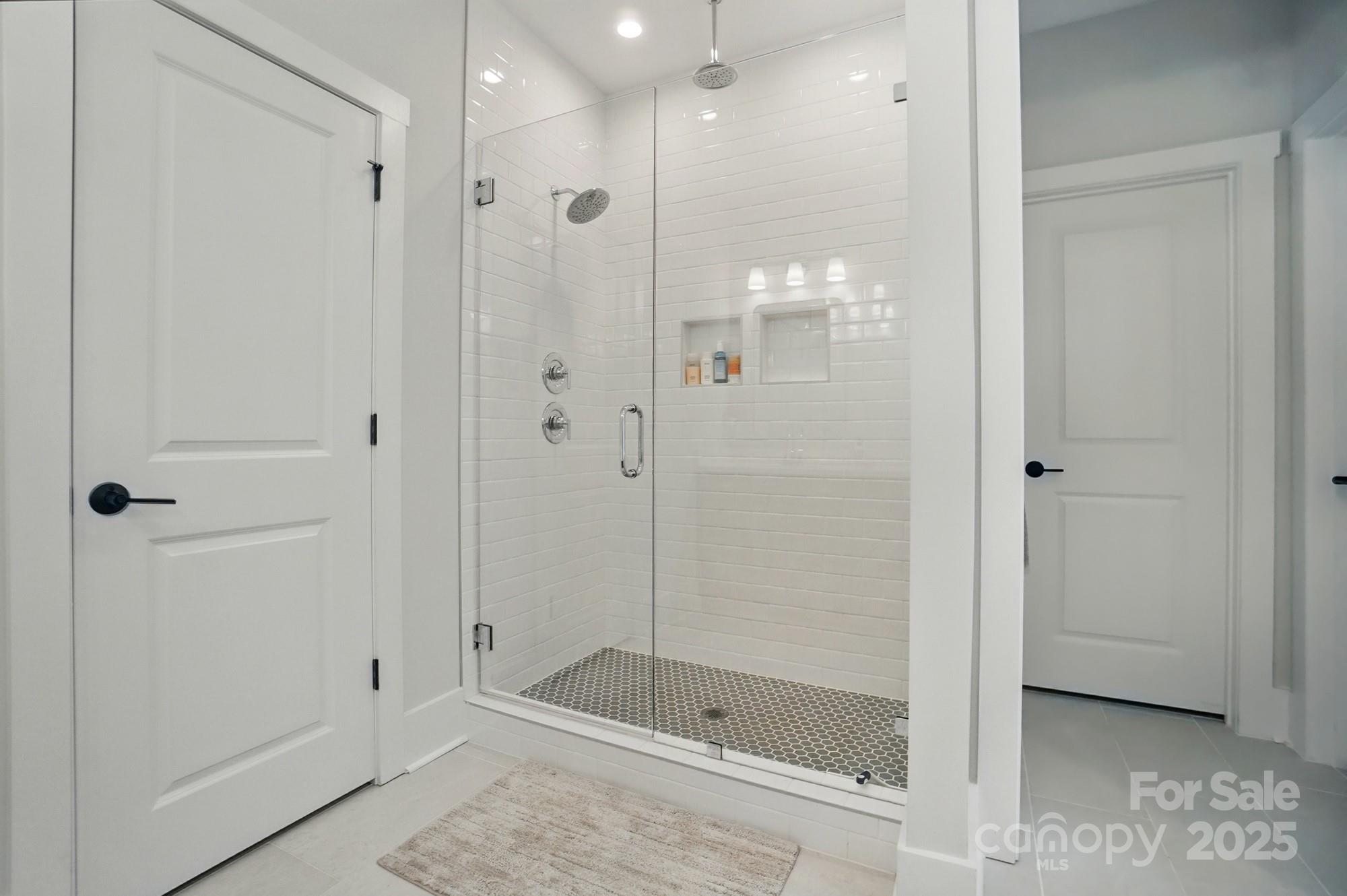 7818 Russell Road Indian Trail, NC 28079 - Photo 27 of 42 a bathroom with a shower and a glass door