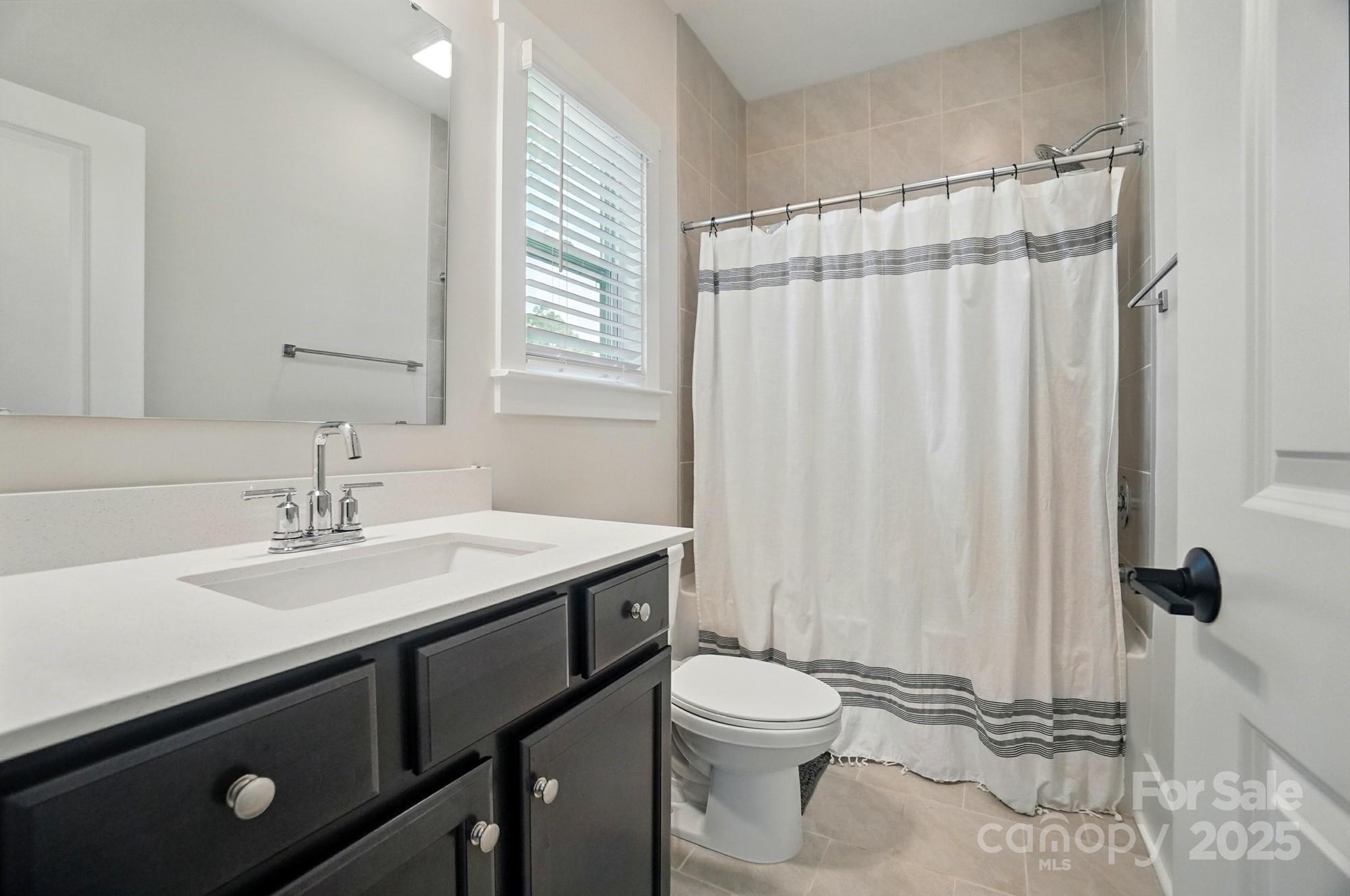 7818 Russell Road Indian Trail, NC 28079 - Photo 31 of 42 a bathroom with a sink a toilet and a mirror