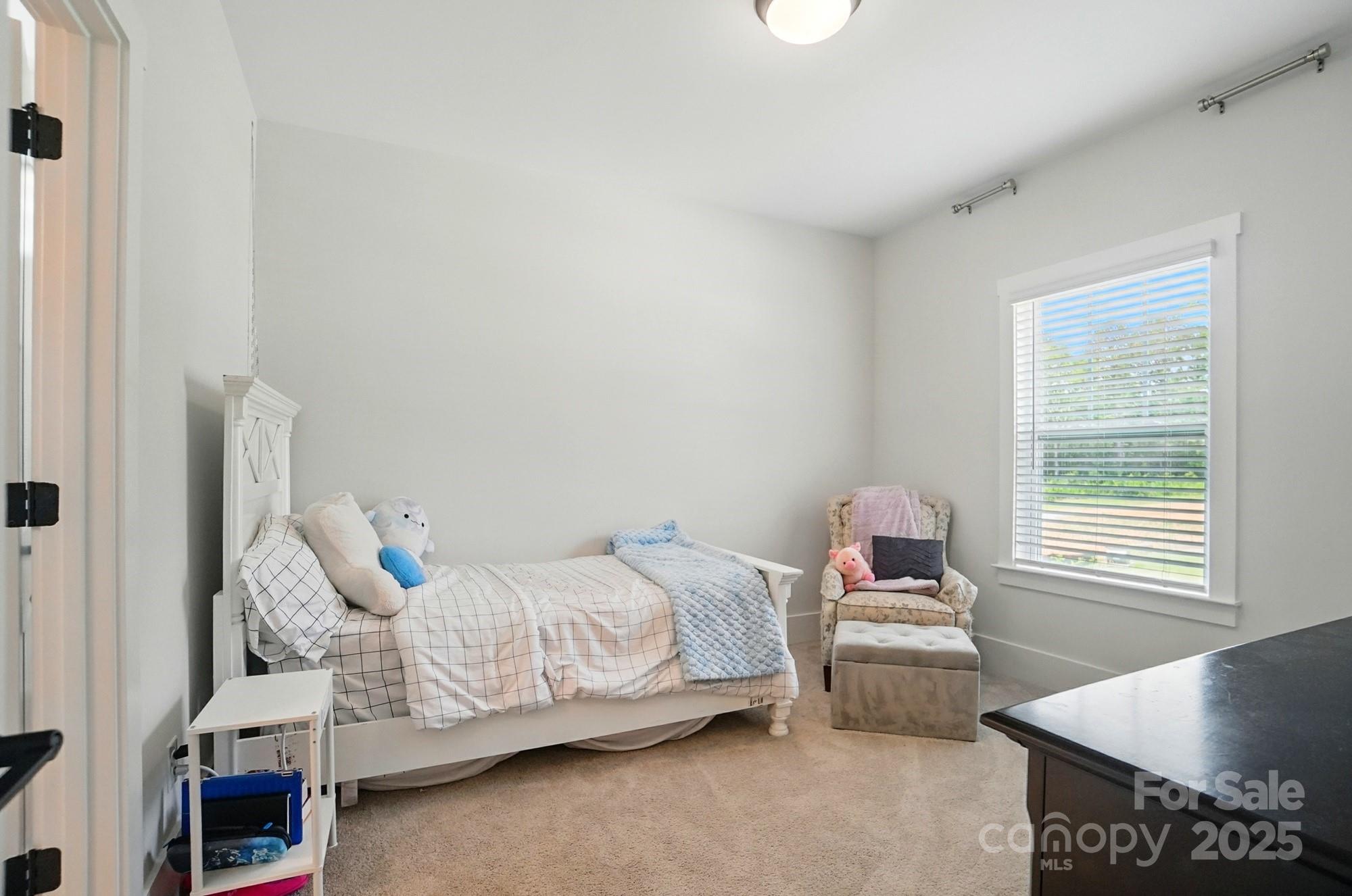 7818 Russell Road Indian Trail, NC 28079 - Photo 32 of 42 a bedroom with a bed and a window