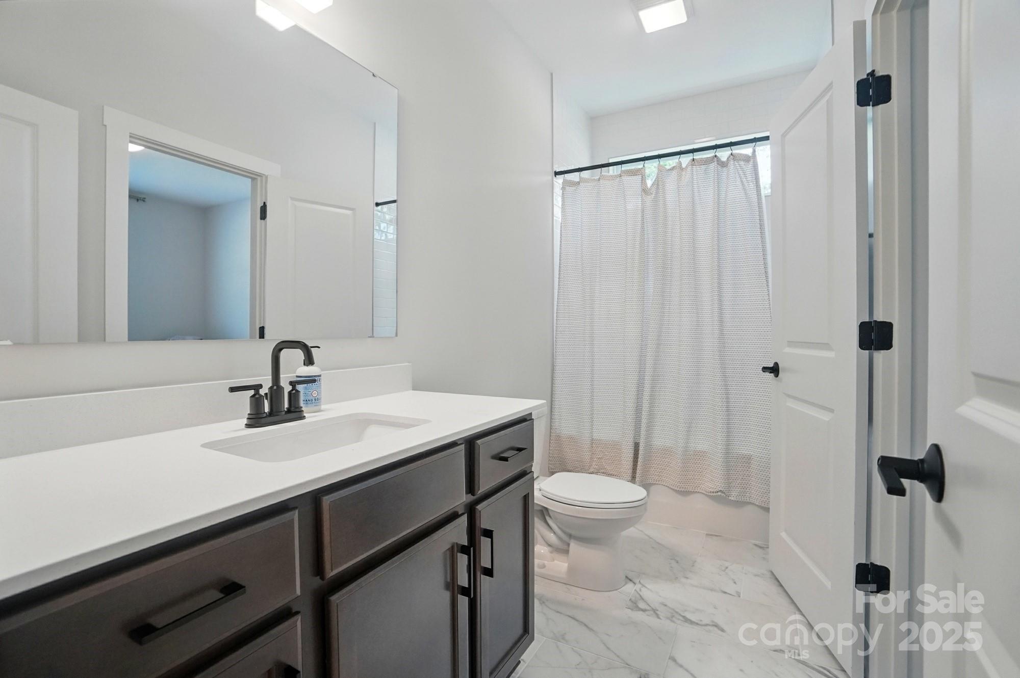 7818 Russell Road Indian Trail, NC 28079 - Photo 33 of 42 a bathroom with a sink a toilet and shower