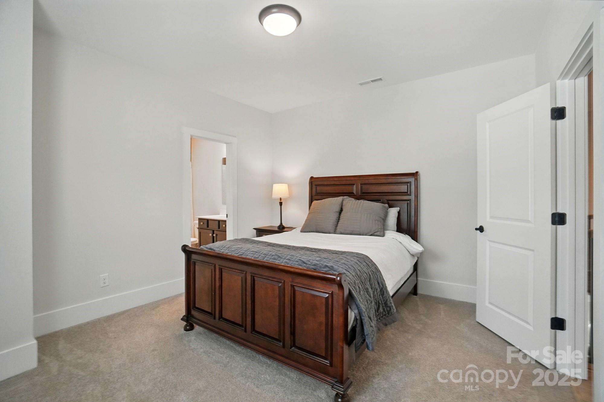 7818 Russell Road Indian Trail, NC 28079 - Photo 34 of 42 a bedroom with a bed and a window