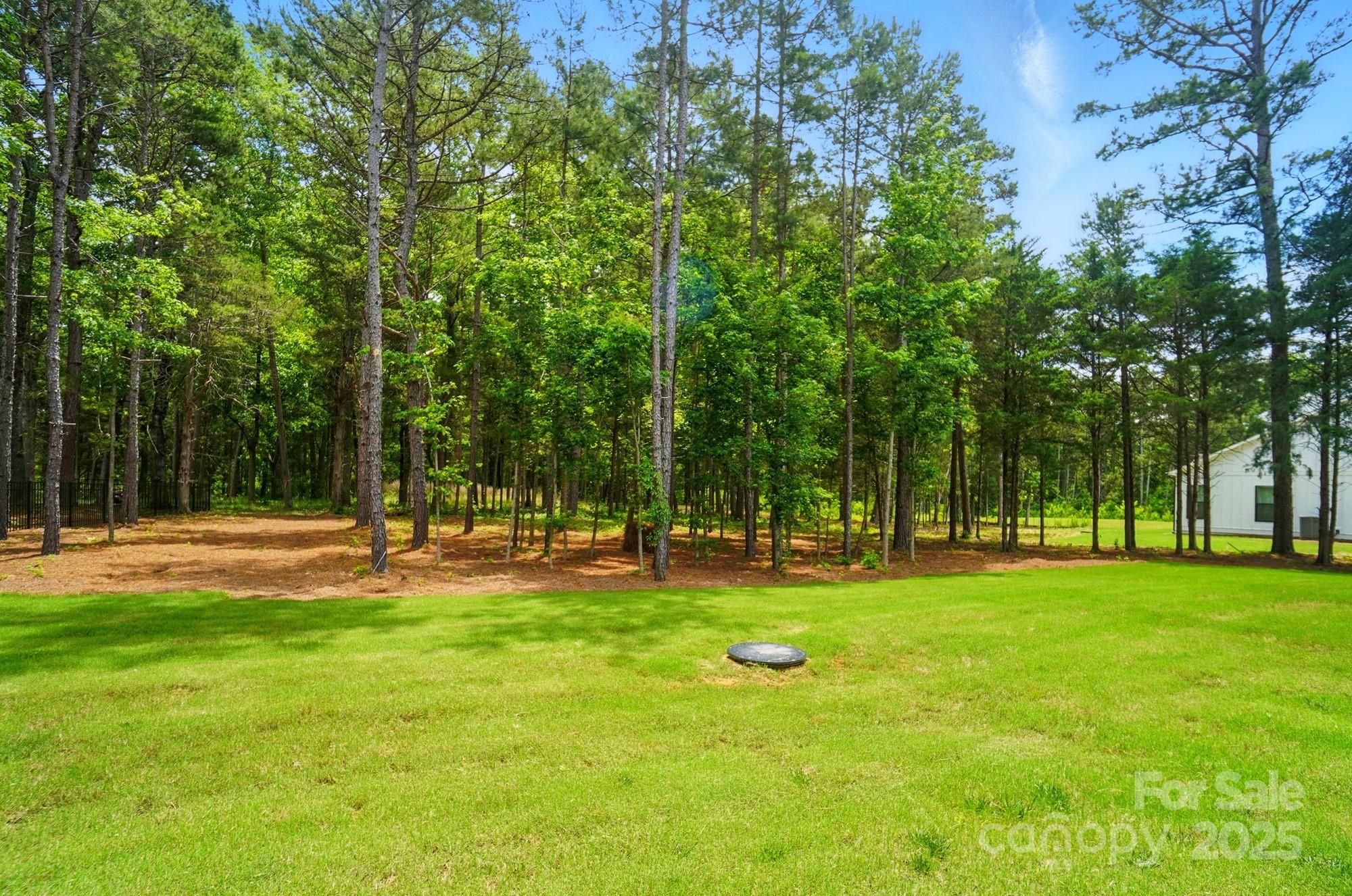 7818 Russell Road Indian Trail, NC 28079 - Photo 40 of 42 a backyard of a house with swimming pool and trees