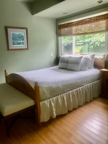 a bed sitting in a bedroom next to a window