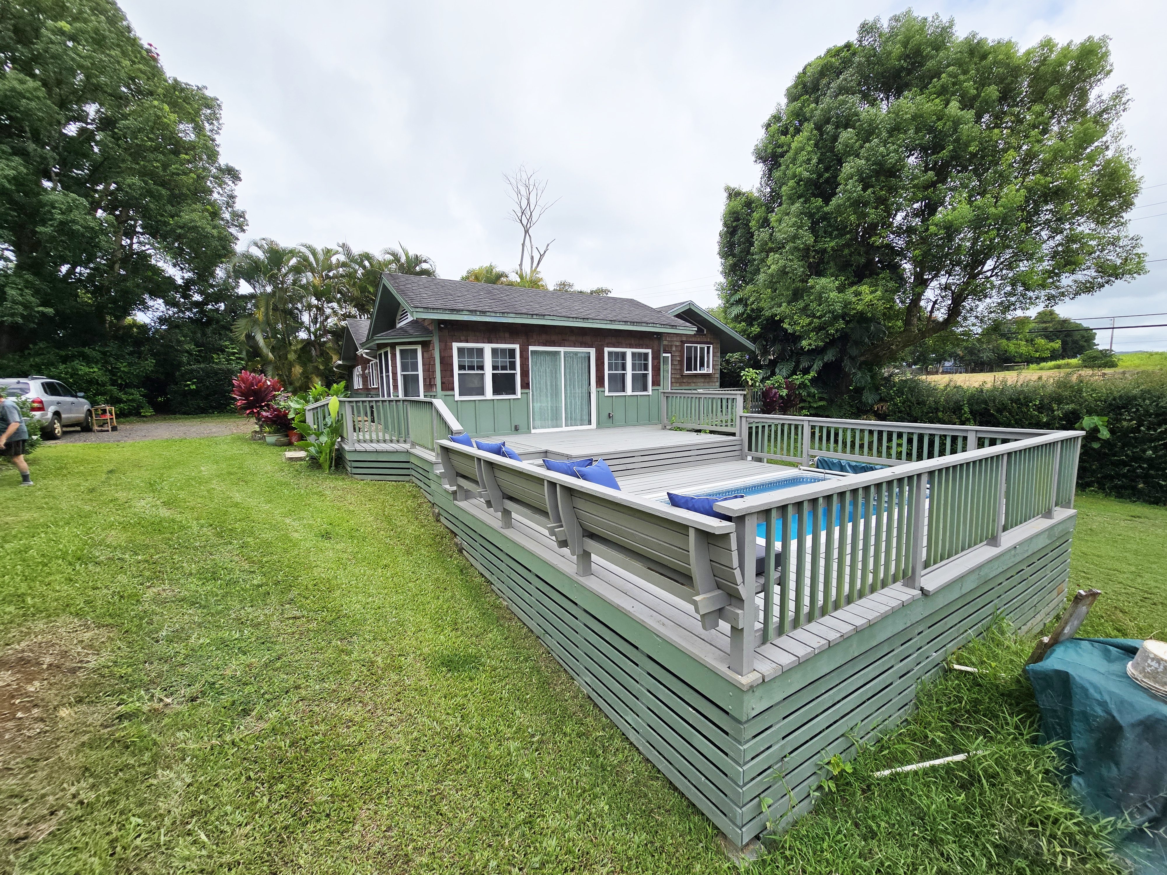 6562 Kahuna Road Kapaa, HI 96746 - Photo 2 of 14 a view of a house with a wooden deck and a yard