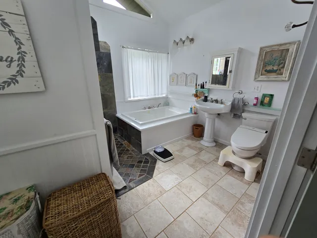 a bathroom with a sink toilet and a mirror