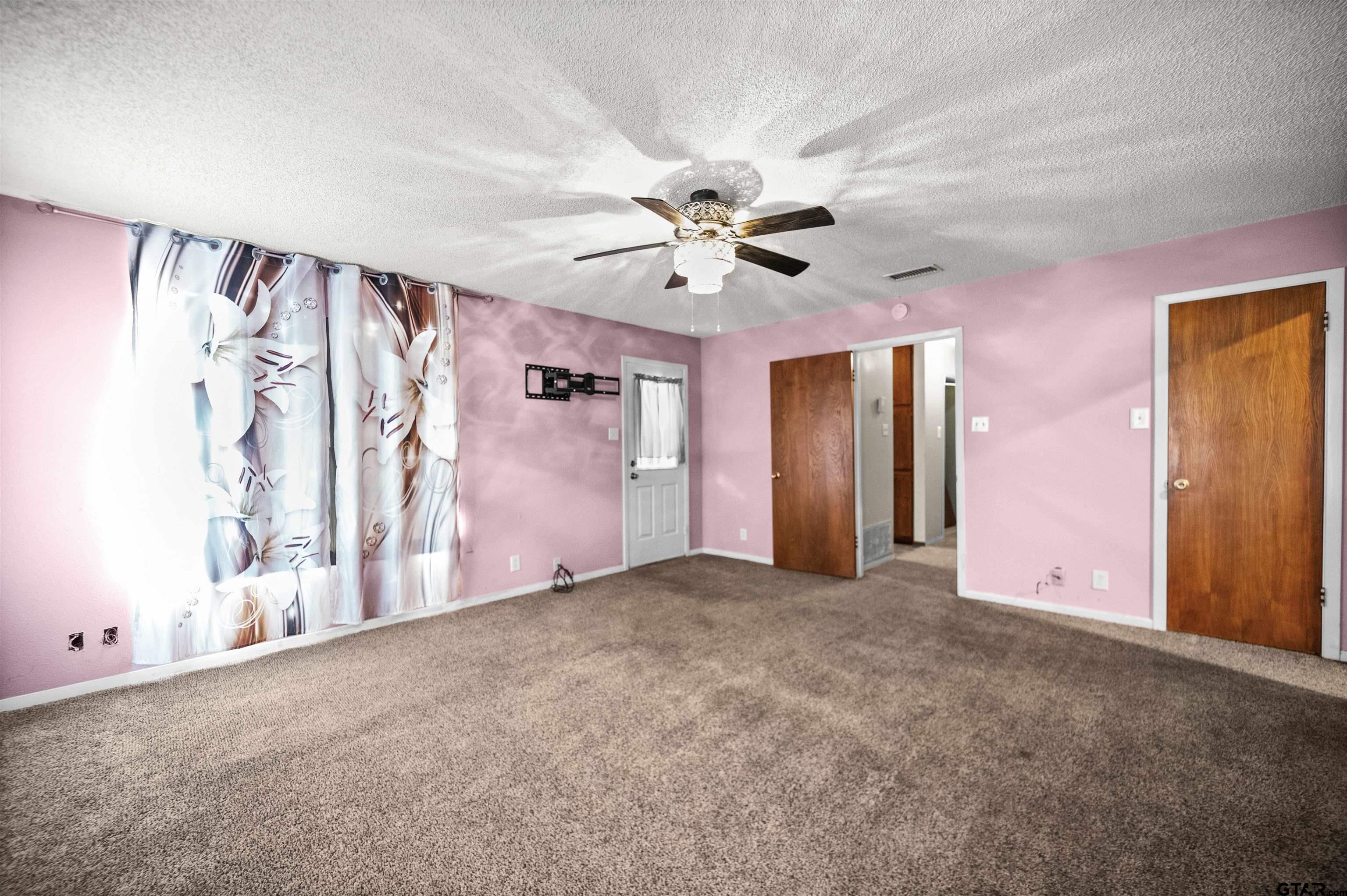 13518 Larry Lane Tyler, TX 75709 - Photo 13 of 28 a view of empty room with ceiling fan