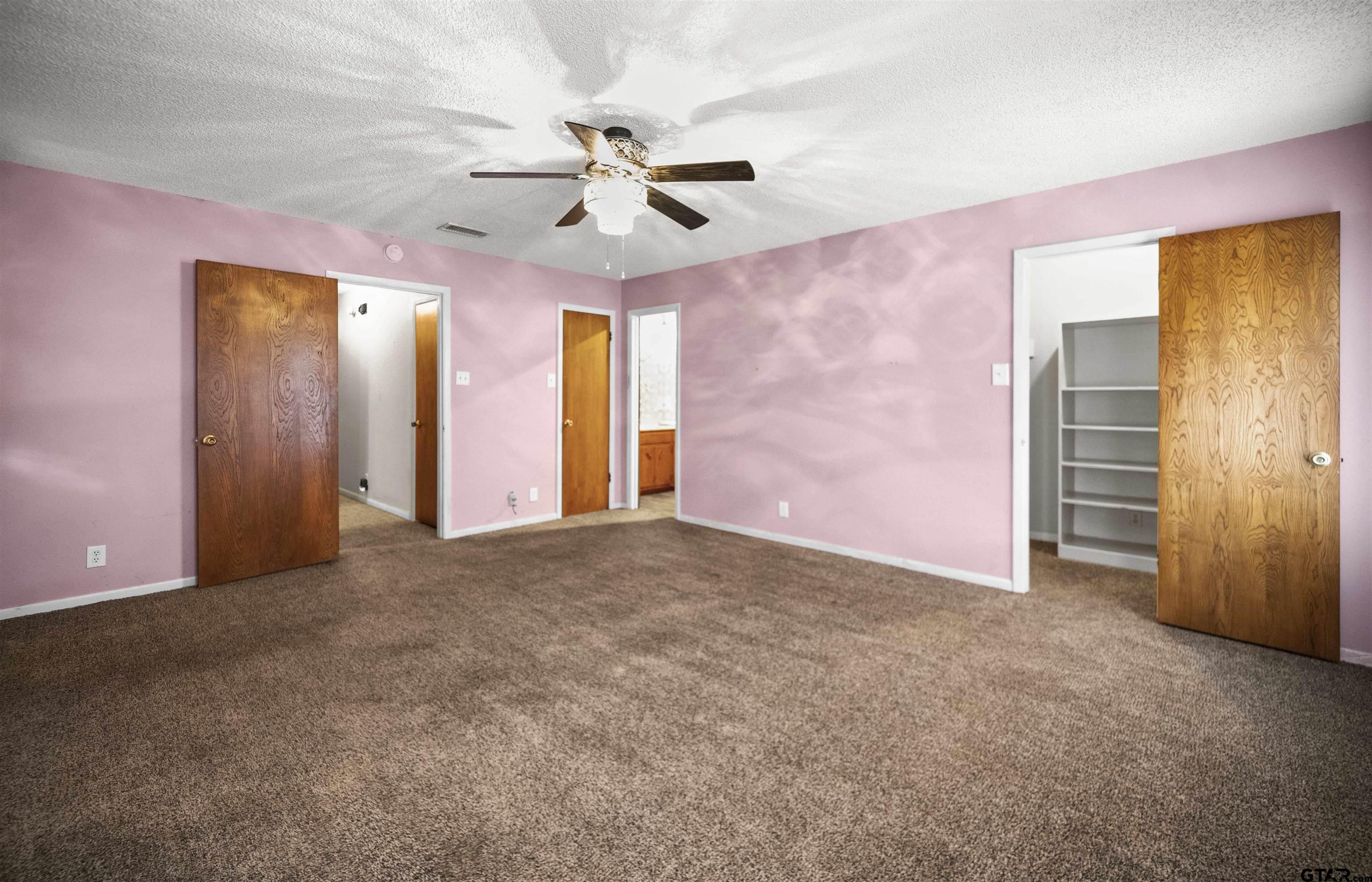 13518 Larry Lane Tyler, TX 75709 - Photo 14 of 28 a view of an empty room with a ceiling fan