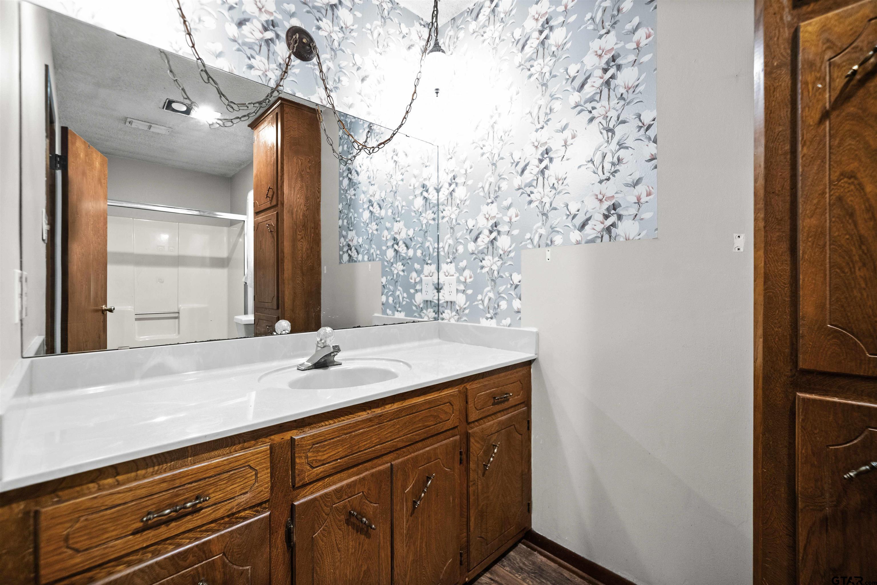 13518 Larry Lane Tyler, TX 75709 - Photo 16 of 28 a sink with a vanity and mirror