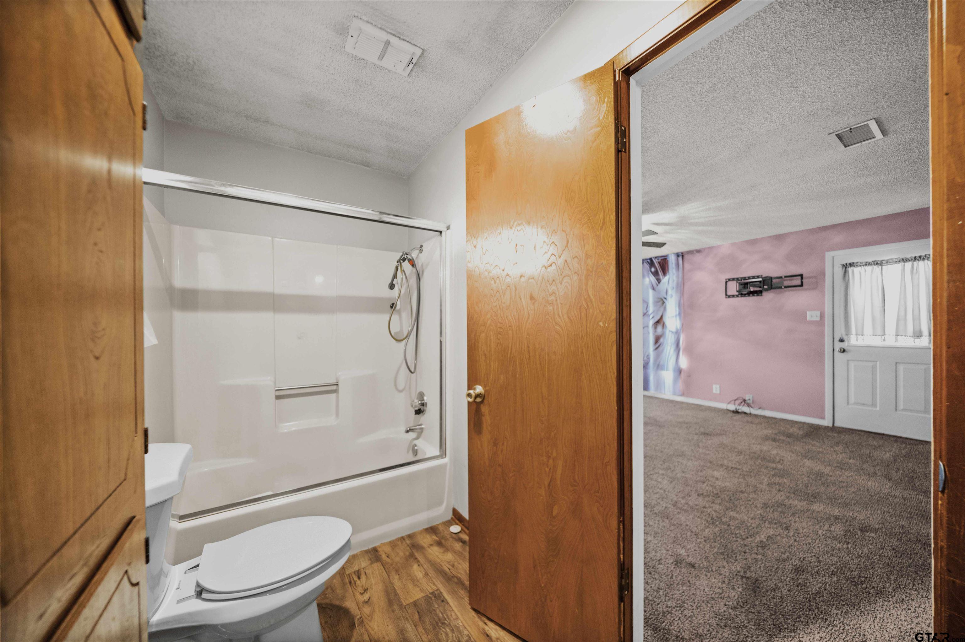 13518 Larry Lane Tyler, TX 75709 - Photo 17 of 28 a bathroom with a granite countertop shower toilet and sink