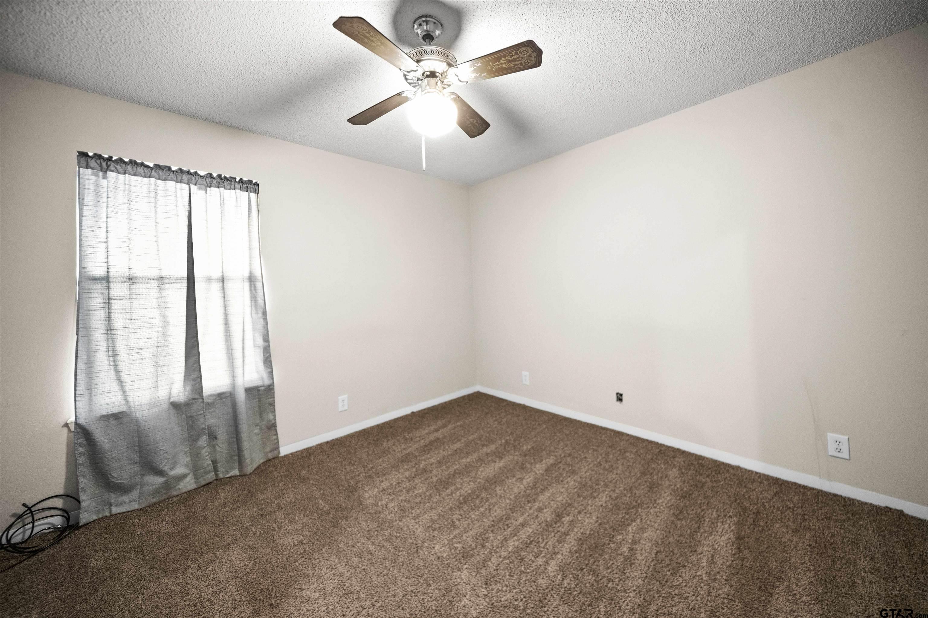 13518 Larry Lane Tyler, TX 75709 - Photo 18 of 28 an empty room with windows and fan
