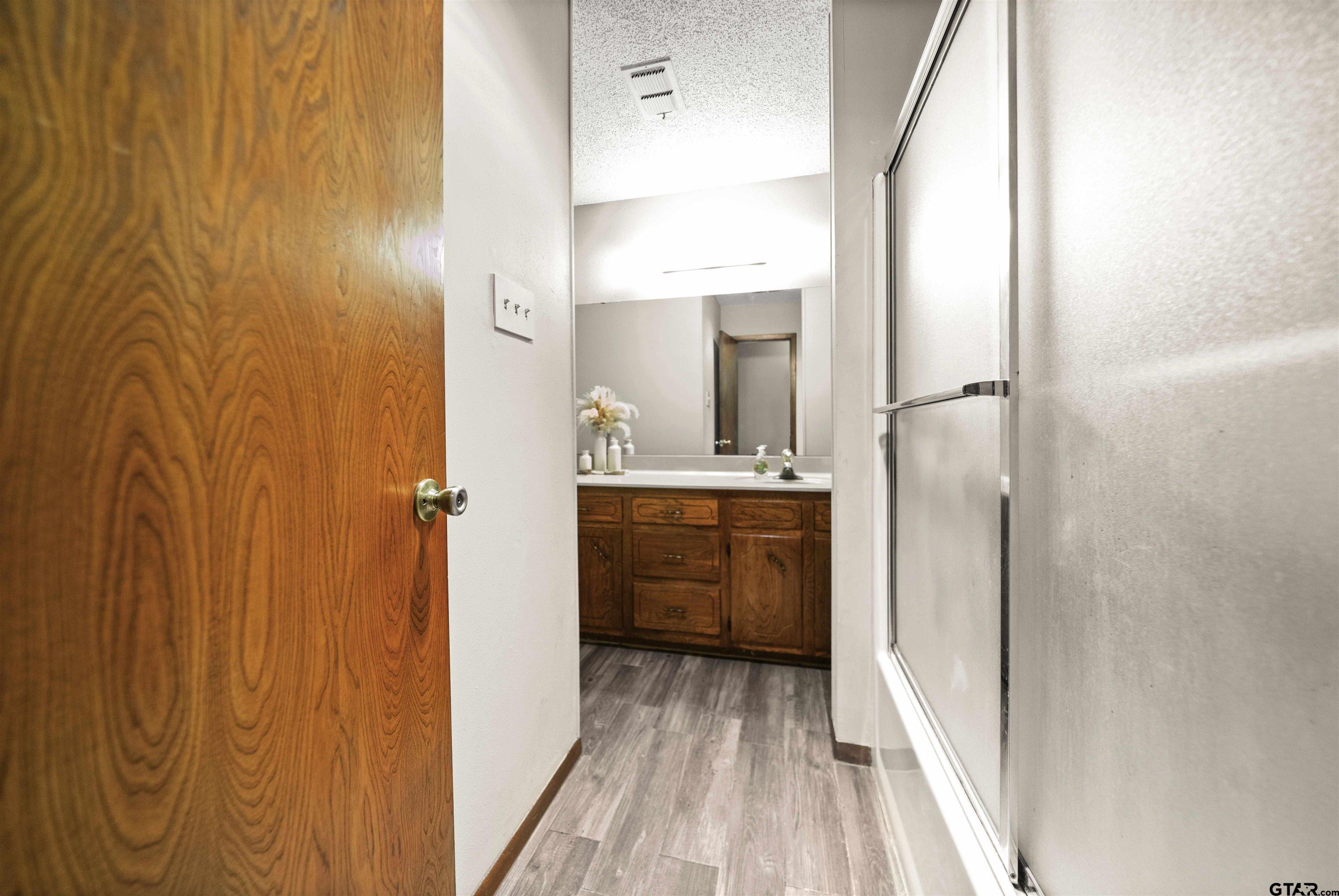 13518 Larry Lane Tyler, TX 75709 - Photo 19 of 28 a bathroom with a sink and a mirror