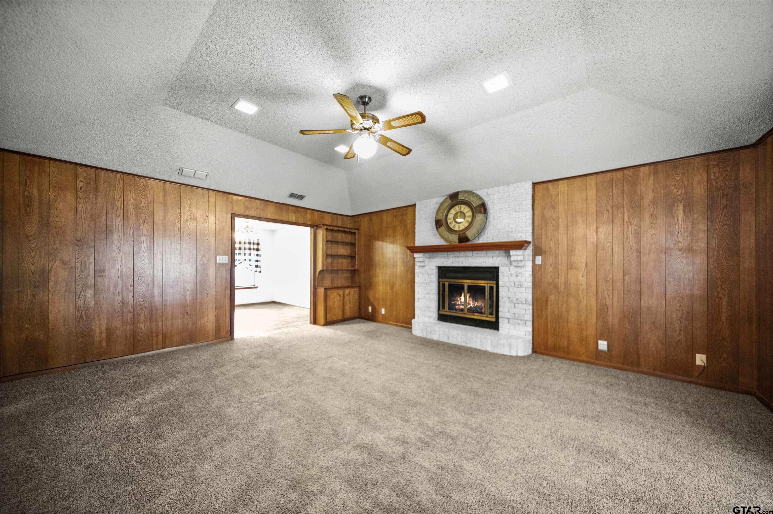 13518 Larry Lane Tyler, TX 75709 - Photo 7 of 28 a view of an empty room with a fireplace and a window