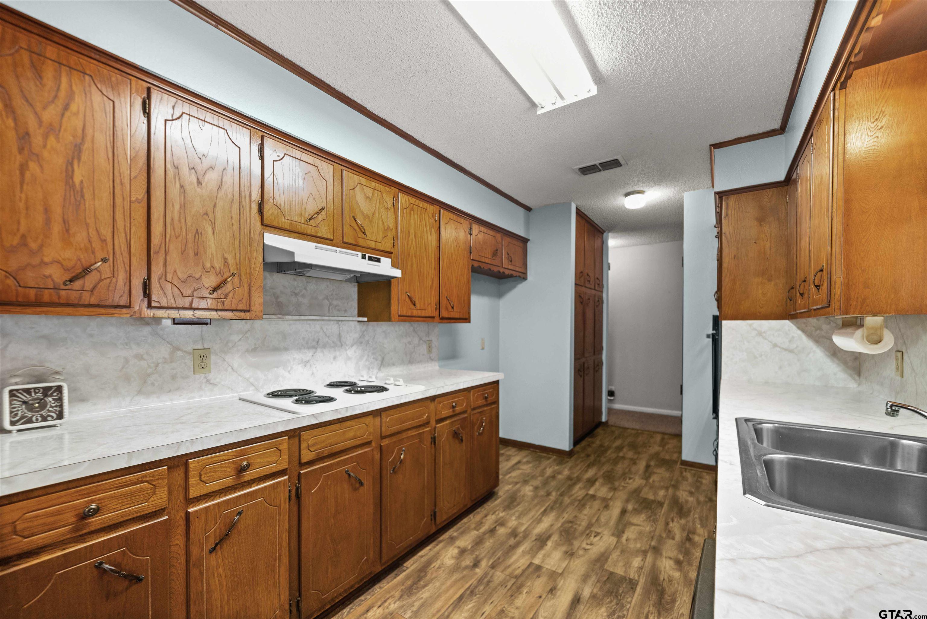 13518 Larry Lane Tyler, TX 75709 - Photo 10 of 28 a kitchen with stainless steel appliances granite countertop a sink stove and cabinets